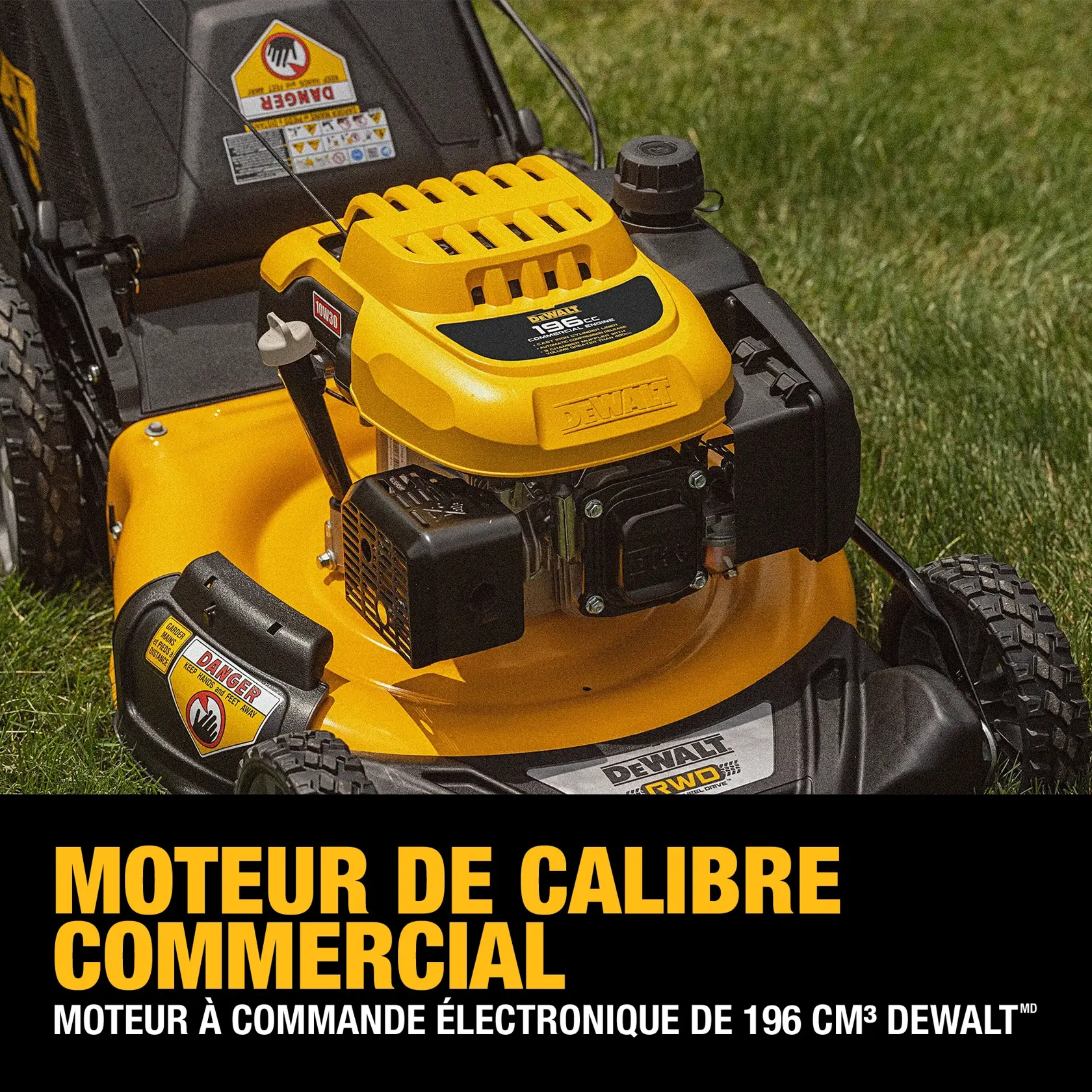 Close-up of a DEWALT lawn mower featuring a 196cc electronically governed commercial-grade engine. The mower is yellow and black, positioned on green grass, with warning labels visible on the machine.