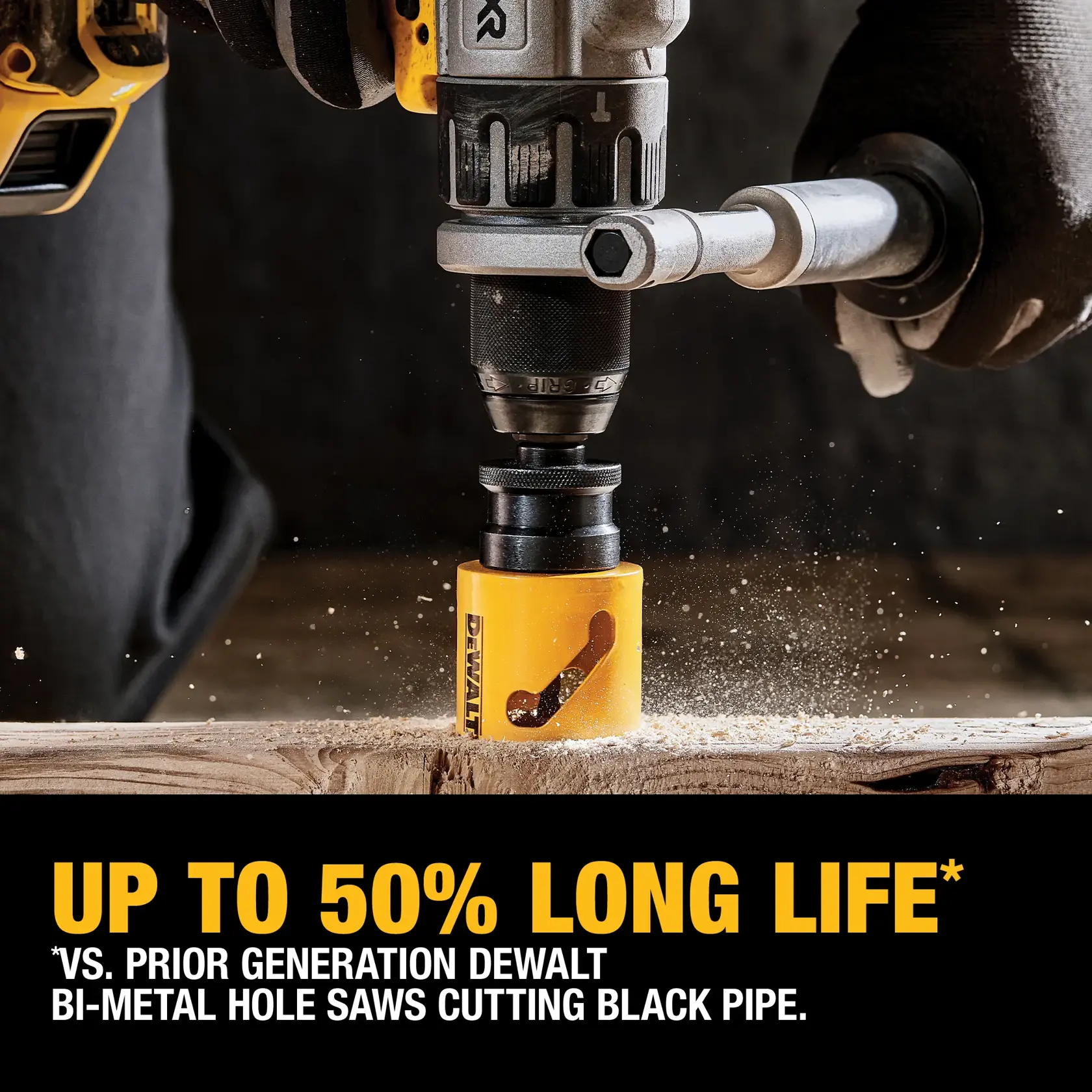A close-up of a DEWALT drill using a yellow bi-metal hole saw to cut through a wooden surface. Text below states 'UP TO 50% LONG LIFE* vs. prior generation DEWALT bi-metal hole saws cutting black pipe.'
