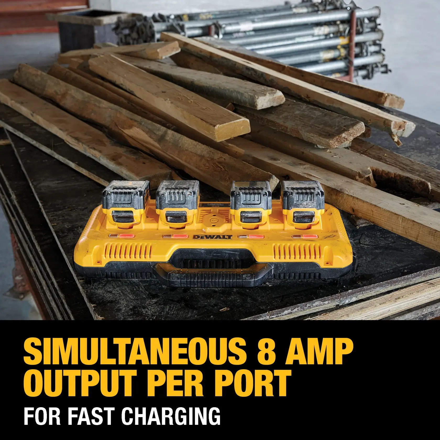A DEWALT DCB104 charger with four batteries attached, displayed on a worktable with wooden planks in the background. The text reads 'Simultaneous 8 amp output per port for fast charging.'