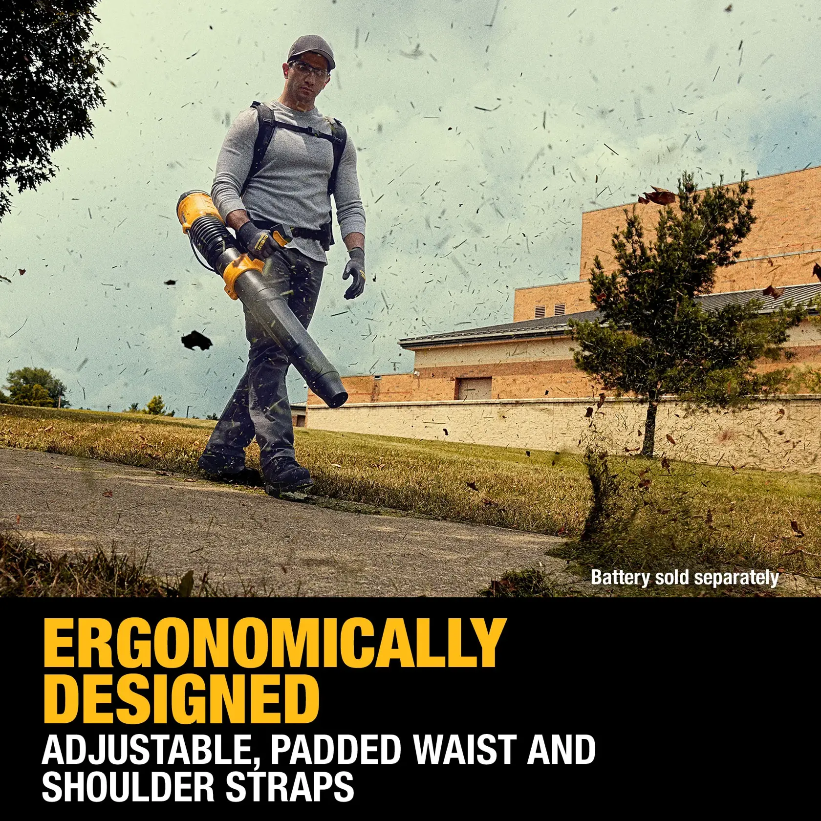 A person is using a DEWALT leaf blower outdoors, wearing padded and adjustable waist and shoulder straps. Leaves are blowing around, and the image highlights ergonomic design features. The text notes that the battery is sold separately.