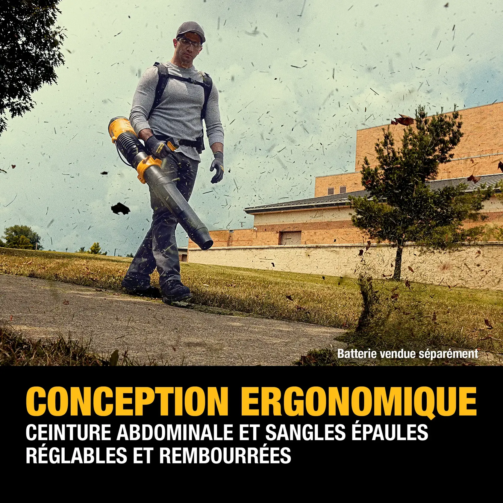 A person is using a DEWALT leaf blower outdoors, wearing padded and adjustable waist and shoulder straps. Leaves are blowing around, and the image highlights ergonomic design features. The text notes that the battery is sold separately.
