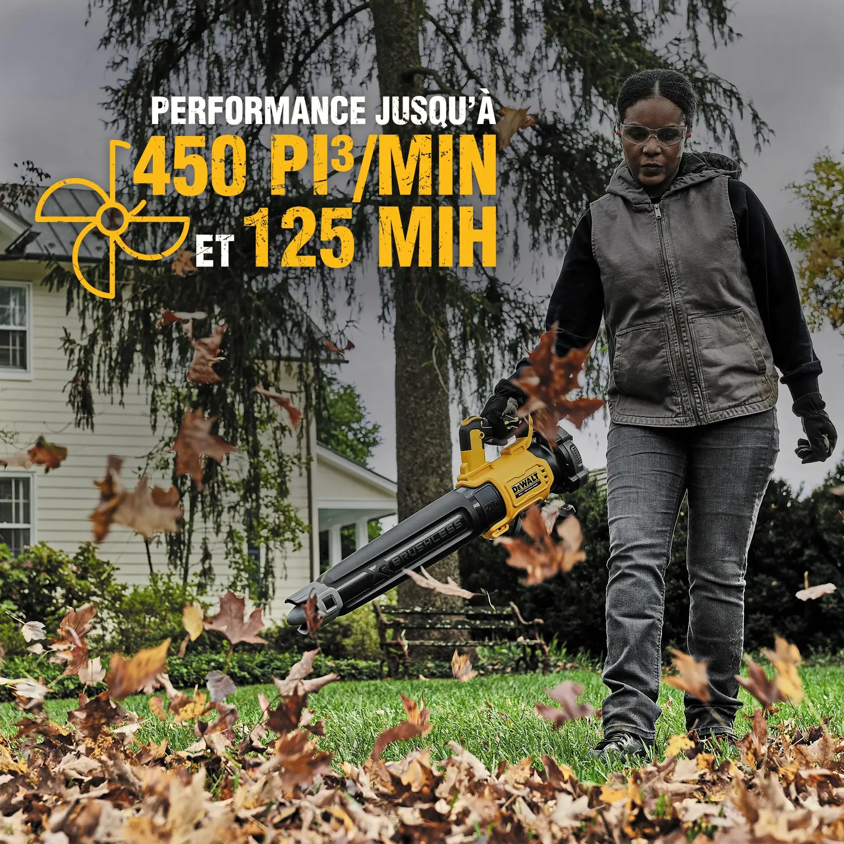 Person using a DEWALT cordless leaf blower outdoors in a yard with autumn leaves. The leaf blower is black and yellow and labeled with the DEWALT logo. Promotional text on the image highlights 'Up to 450 CFM and 125 MPH performance.' The person's face is obscured.