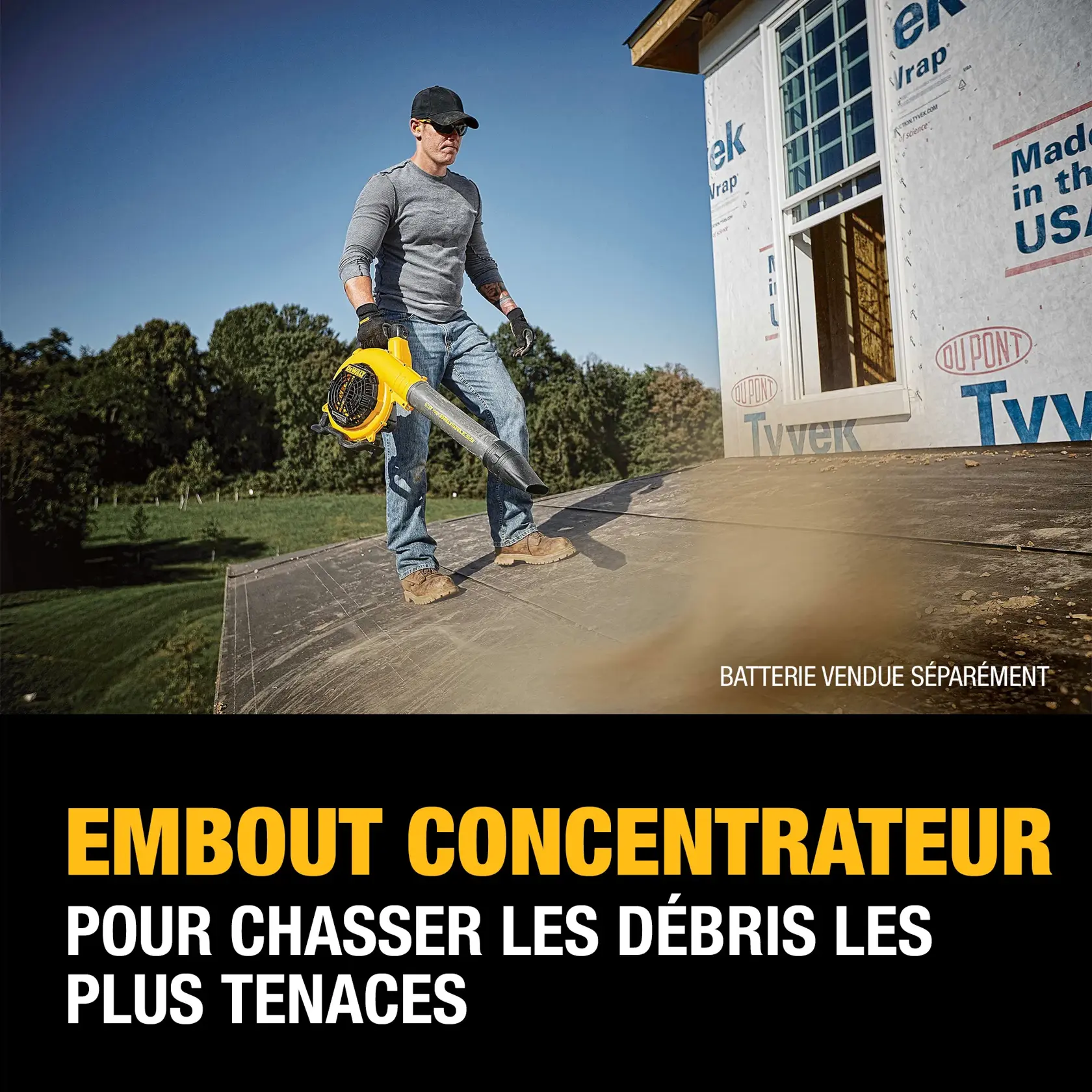 A person stands on a roof using a DEWALT blower with a flat nozzle, clearing persistent debris. The text highlights that the flat nozzle helps power through stubborn debris and notes that the battery is sold separately.