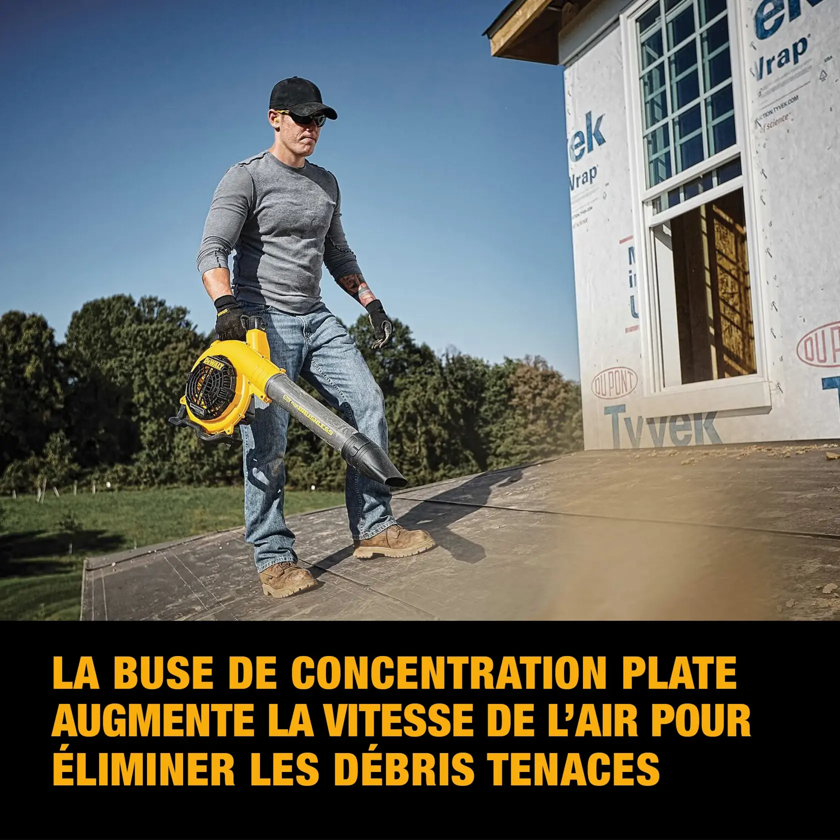 A person using a DEWALT handheld blower to clear debris inside a wooden building under construction. The blower is yellow and black, and text below states: 'Up to 423 CFM air volume at 129 MPH.'