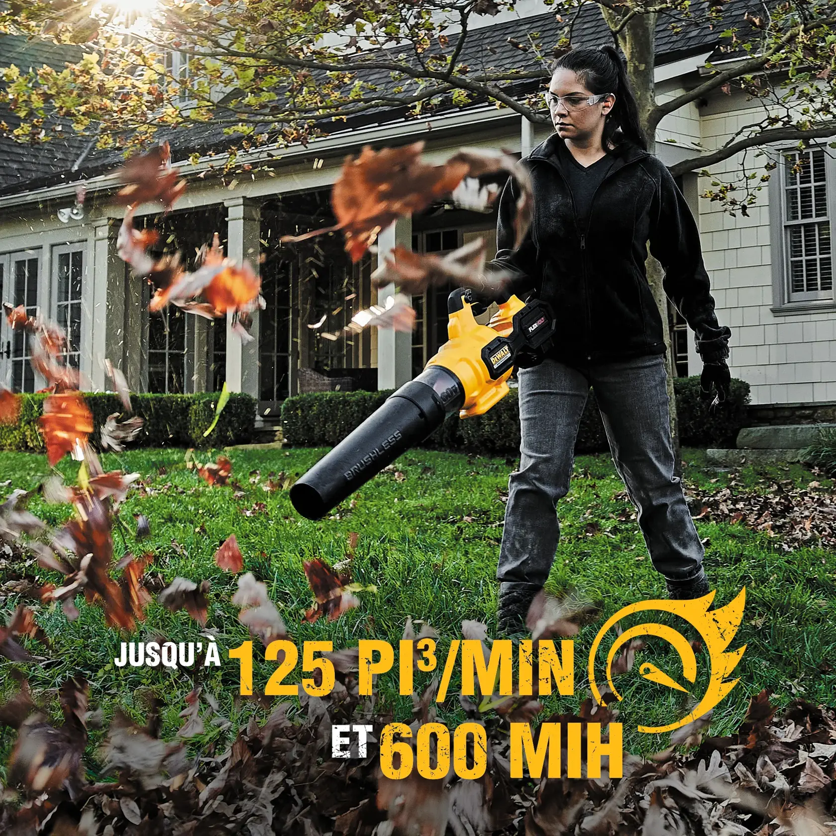 A person using a DEWALT cordless leaf blower outside a house, blowing leaves off the lawn. The product is yellow and black, and text on the image highlights its performance: up to 125 cubic feet per minute and 600 miles per hour.