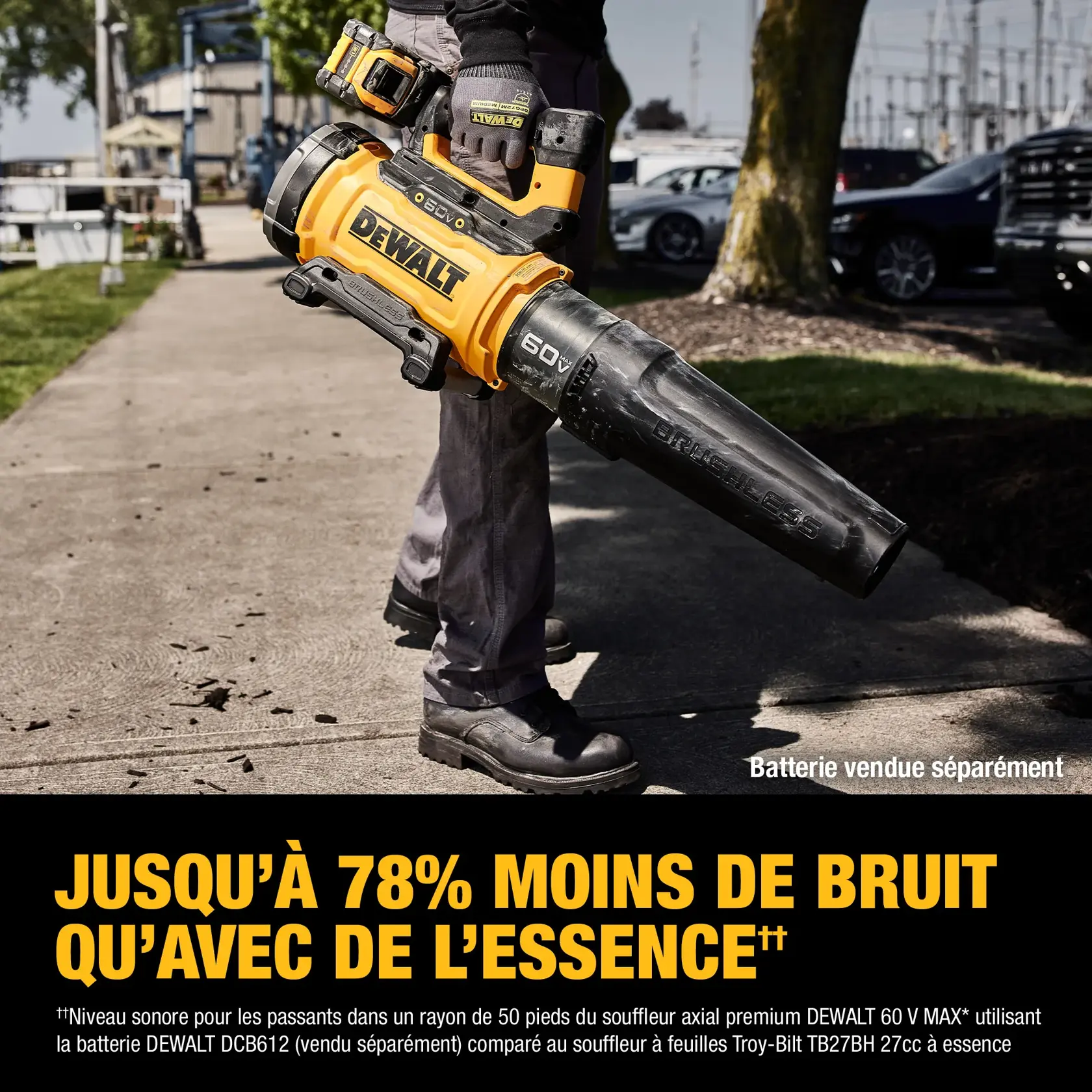 A person holding a DEWALT 60V MAX Premium Axial Blower on a sidewalk, with text indicating the blower produces up to 78% less noise than gas-powered models. The blower is yellow and black, and the battery is sold separately.