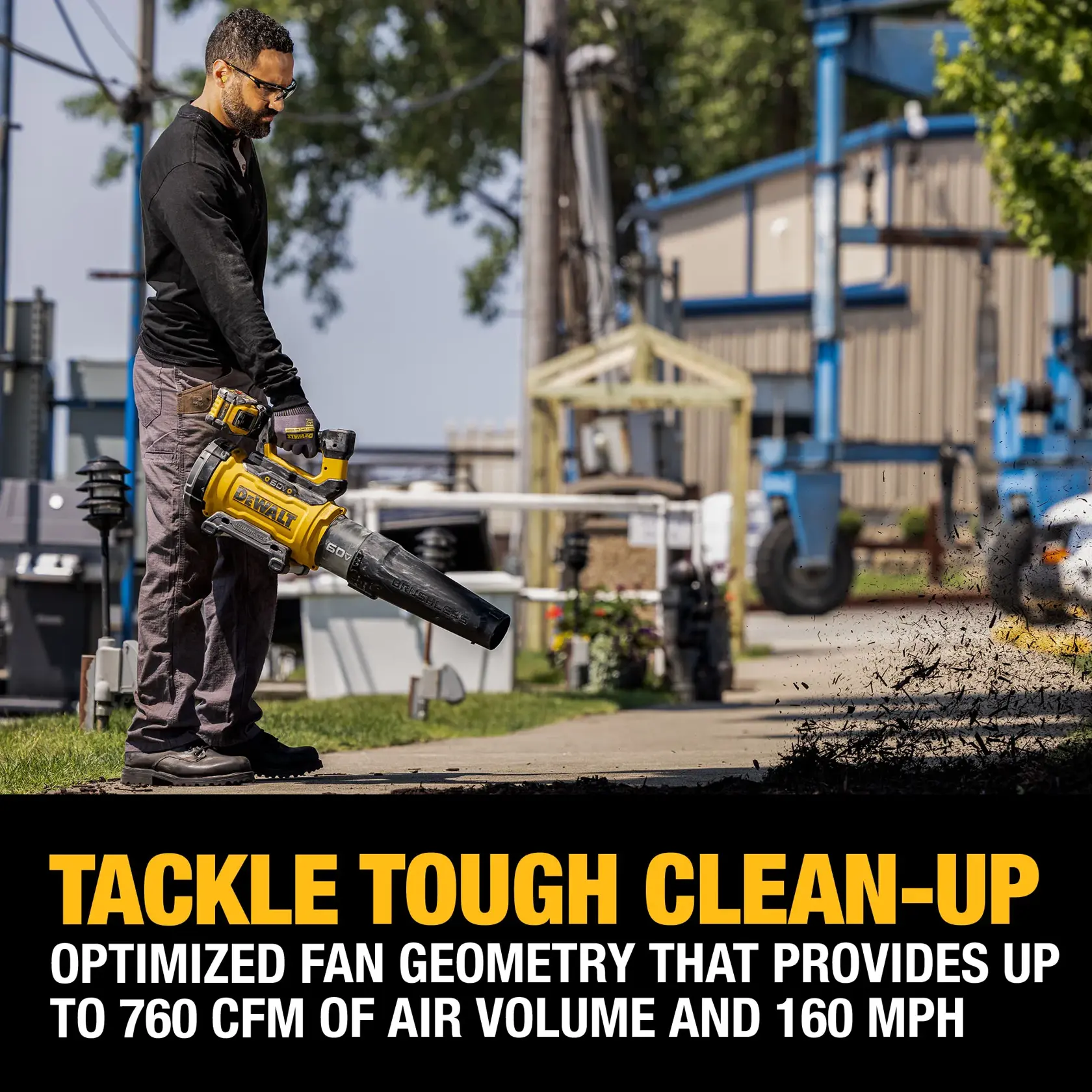 A person is using a DEWALT cordless leaf blower outdoors. The image includes a text overlay stating, 'Tackle Tough Clean-Up. Optimized fan geometry that provides up to 760 CFM of air volume and 160 MPH.' The person is blowing debris off a sidewalk, and there are industrial and outdoor elements in the background.