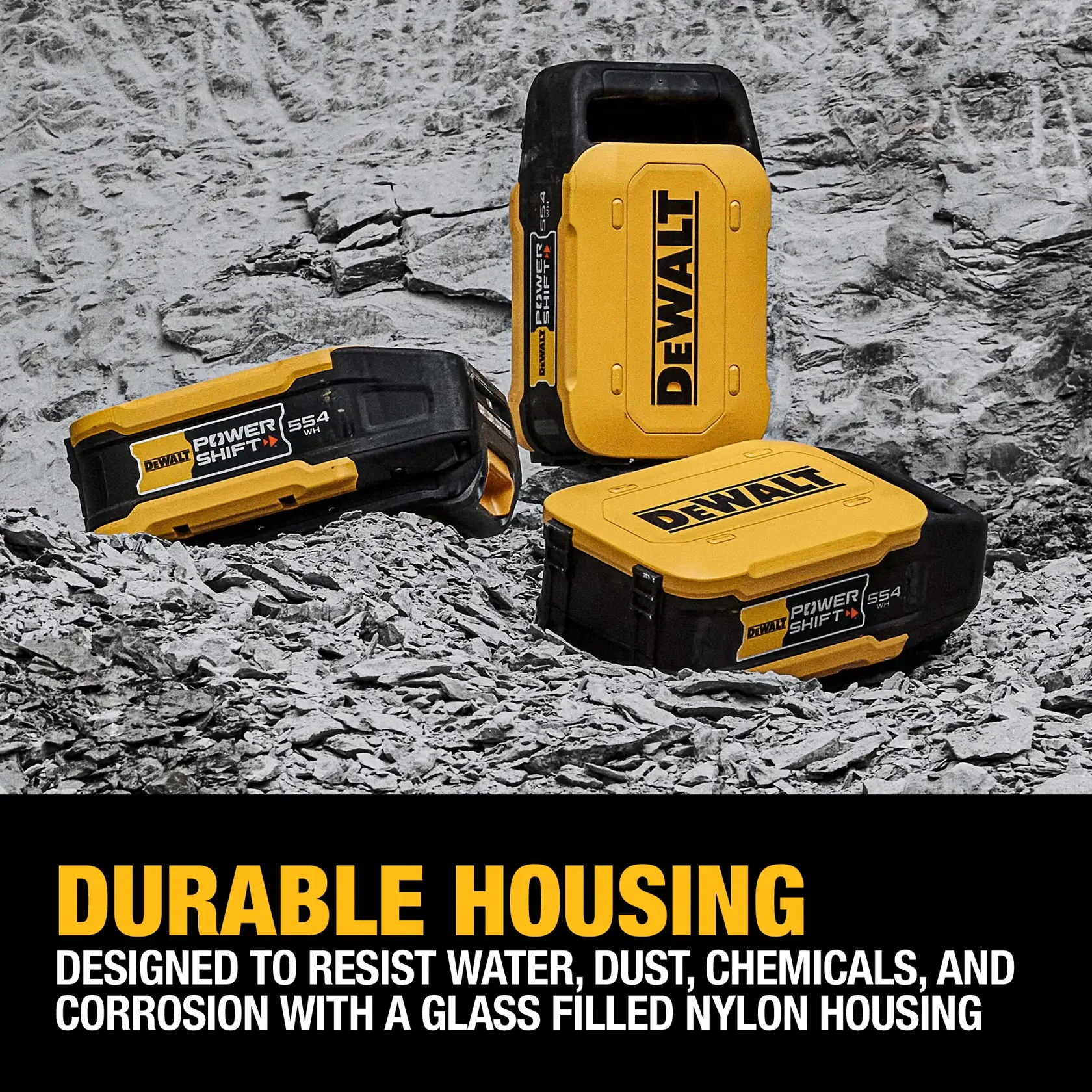 Three DEWALT Power Shift SS4 battery packs with durable glass-filled nylon housing are displayed on a rocky surface. The packs are designed to resist water, dust, chemicals, and corrosion.