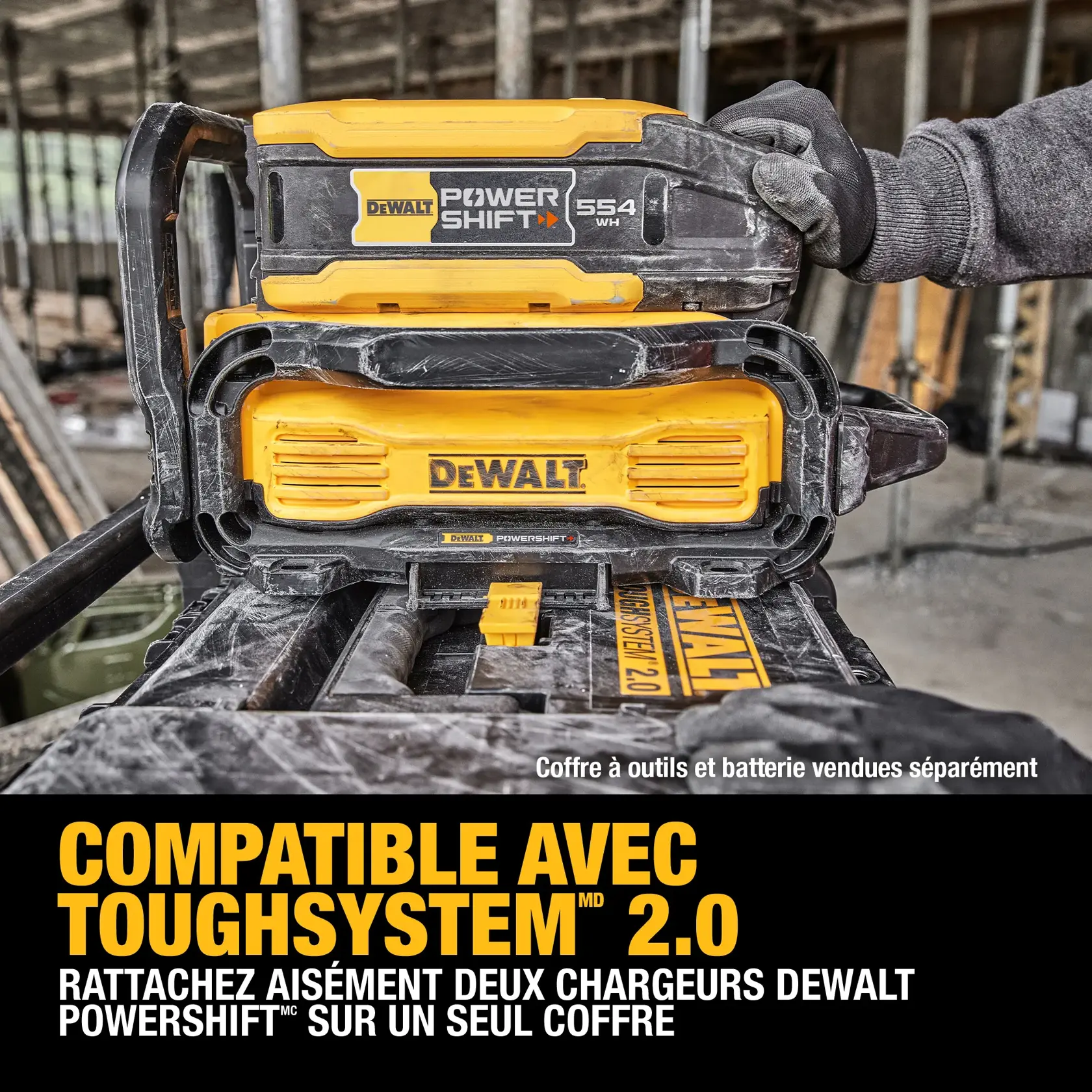 A DEWALT ToughSystem 2.0 box with two DEWALT PowerShift chargers connected on top, shown at a construction site with a gloved hand placing a charger. Text reads: 'ToughSystem 2.0 Compatibility. Easily connect two DEWALT PowerShift chargers on one box. Tool box and battery sold separately.'