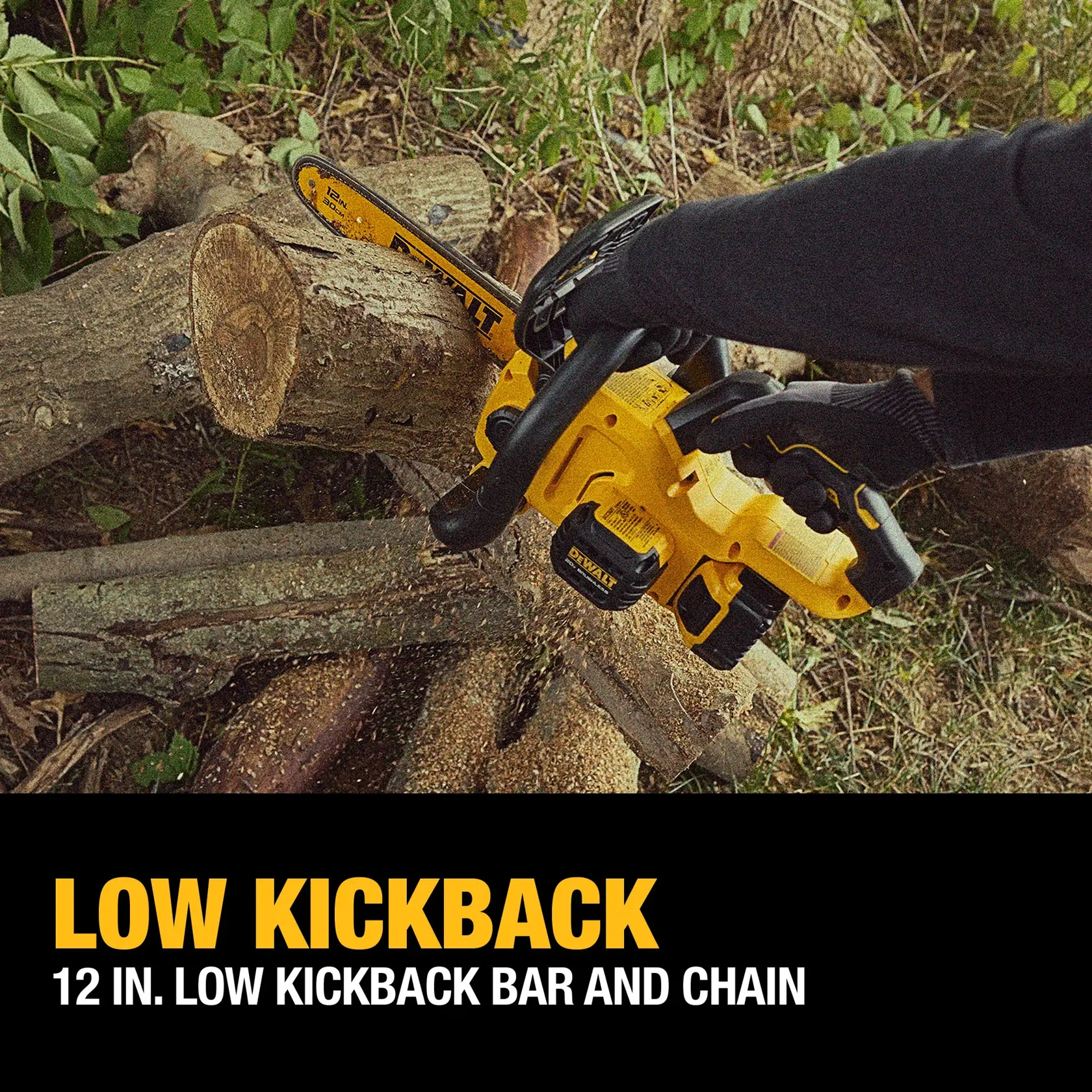 A person wearing gloves uses a yellow DEWALT cordless chainsaw with a 12-inch low kickback bar and chain to cut logs outdoors. Marketing text at the bottom highlights 'LOW KICKBACK' and '12 IN. LOW KICKBACK BAR AND CHAIN'.