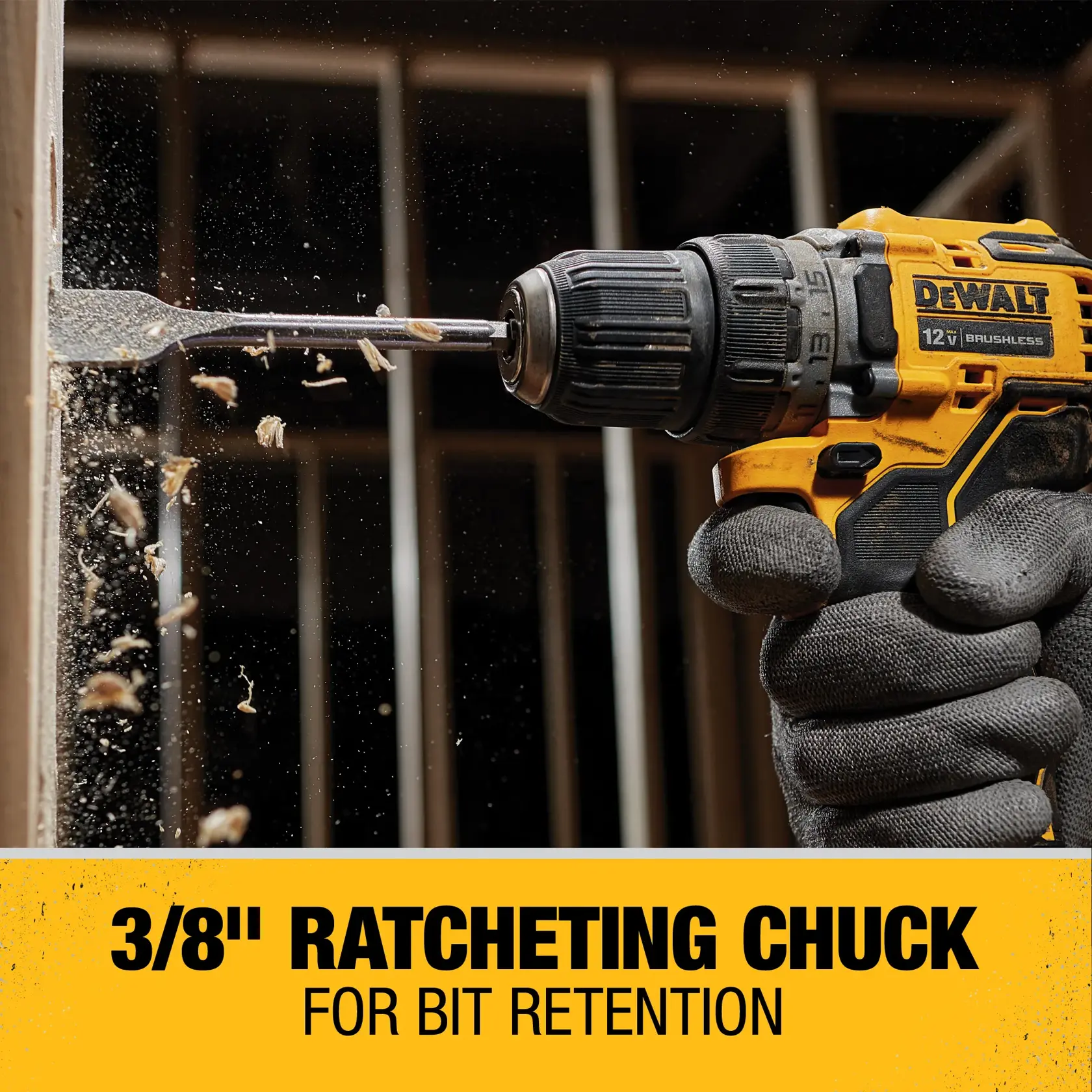 A close-up of a person wearing gloves using a DEWALT 12V brushless cordless drill with a 3/8 inch ratcheting chuck, drilling into a wooden surface. Wood chips are flying as the drill bit penetrates the wood. The image highlights the feature of the ratcheting chuck for better bit retention.