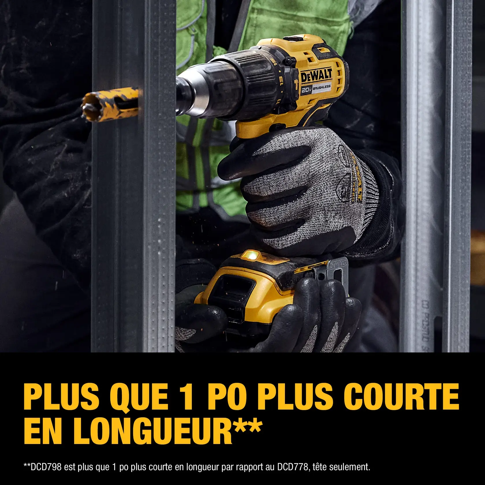A person wearing work gloves uses a DEWALT 20V cordless drill, model DCD798D1, to drill into a metal frame. The image highlights that the tool is over 1 inch shorter in length compared to another model, with bold yellow text at the bottom.