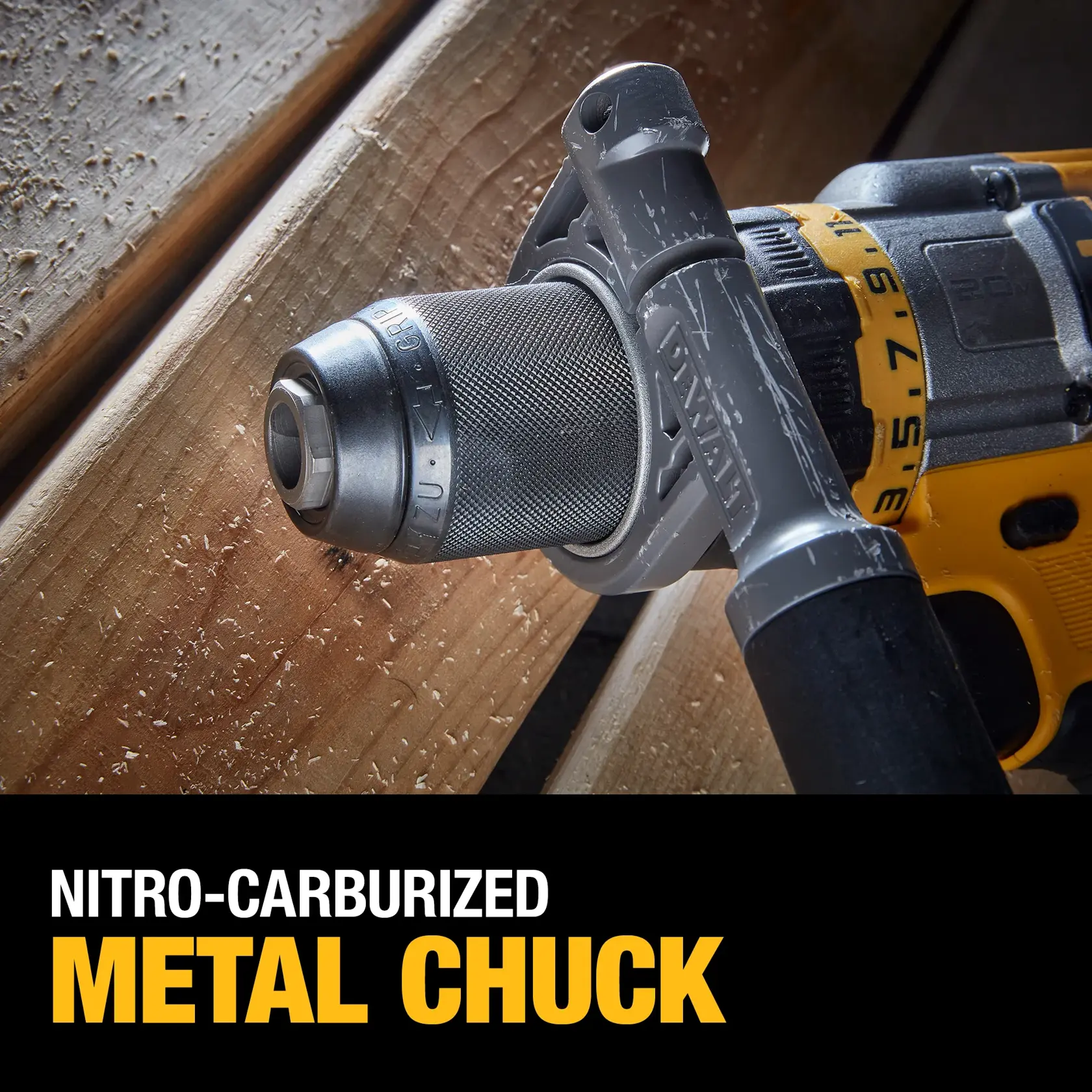 A person uses a DEWALT cordless power drill, model DCD999T1, to drill into a wooden floor. The person is wearing black gloves and working in a construction or renovation setting, with wood shavings flying around.