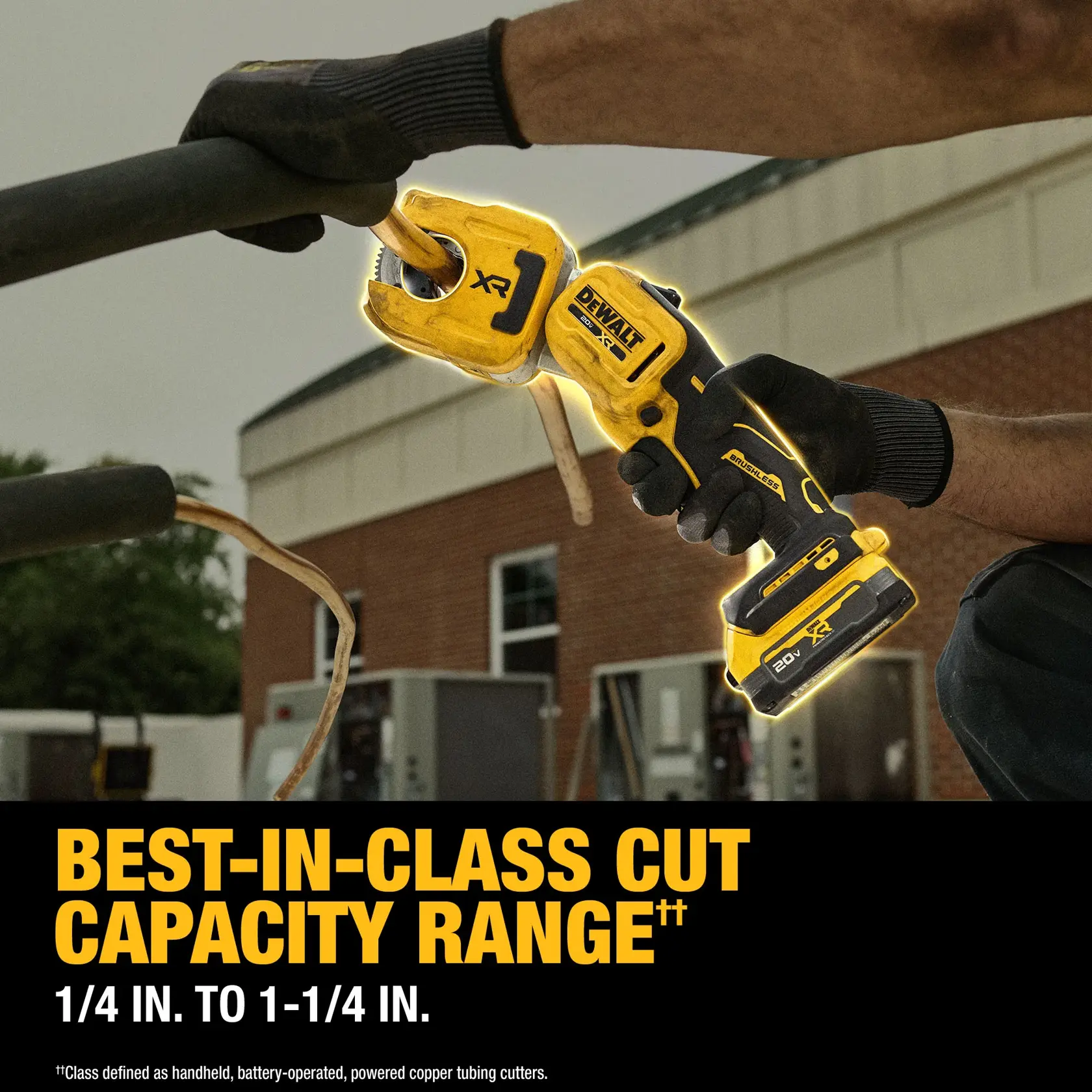 DEWALT cordless copper tubing cutter in use outdoors, cutting a pipe. Best-in-class cut capacity noted.