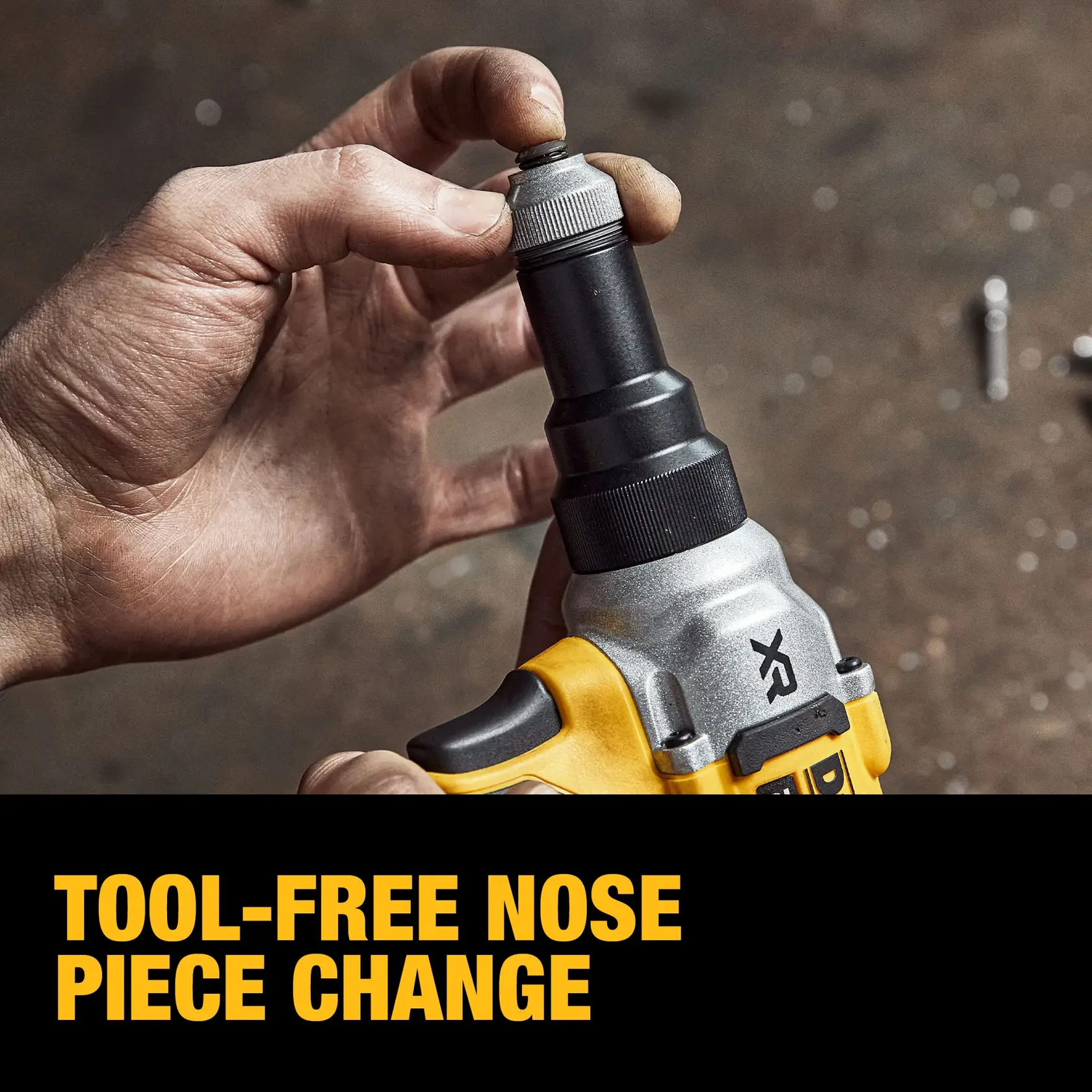 A close-up of a hand changing the nose piece on a DEWALT tool without using additional tools, demonstrating easy tool-free nose piece change.