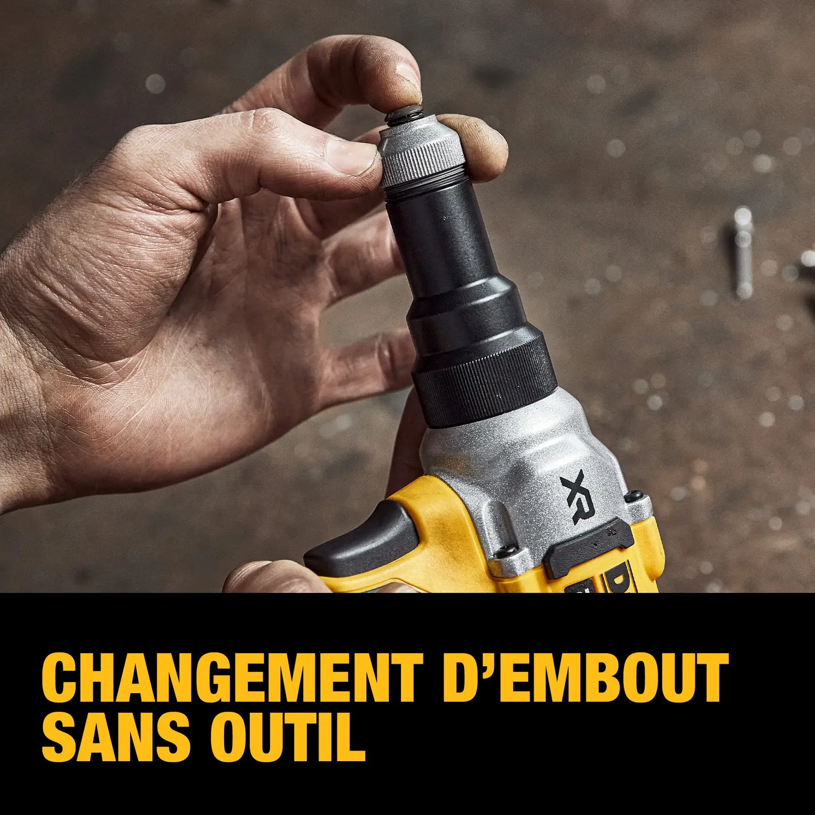 A close-up of a hand changing the nose piece on a DEWALT tool without using additional tools, demonstrating easy tool-free nose piece change.