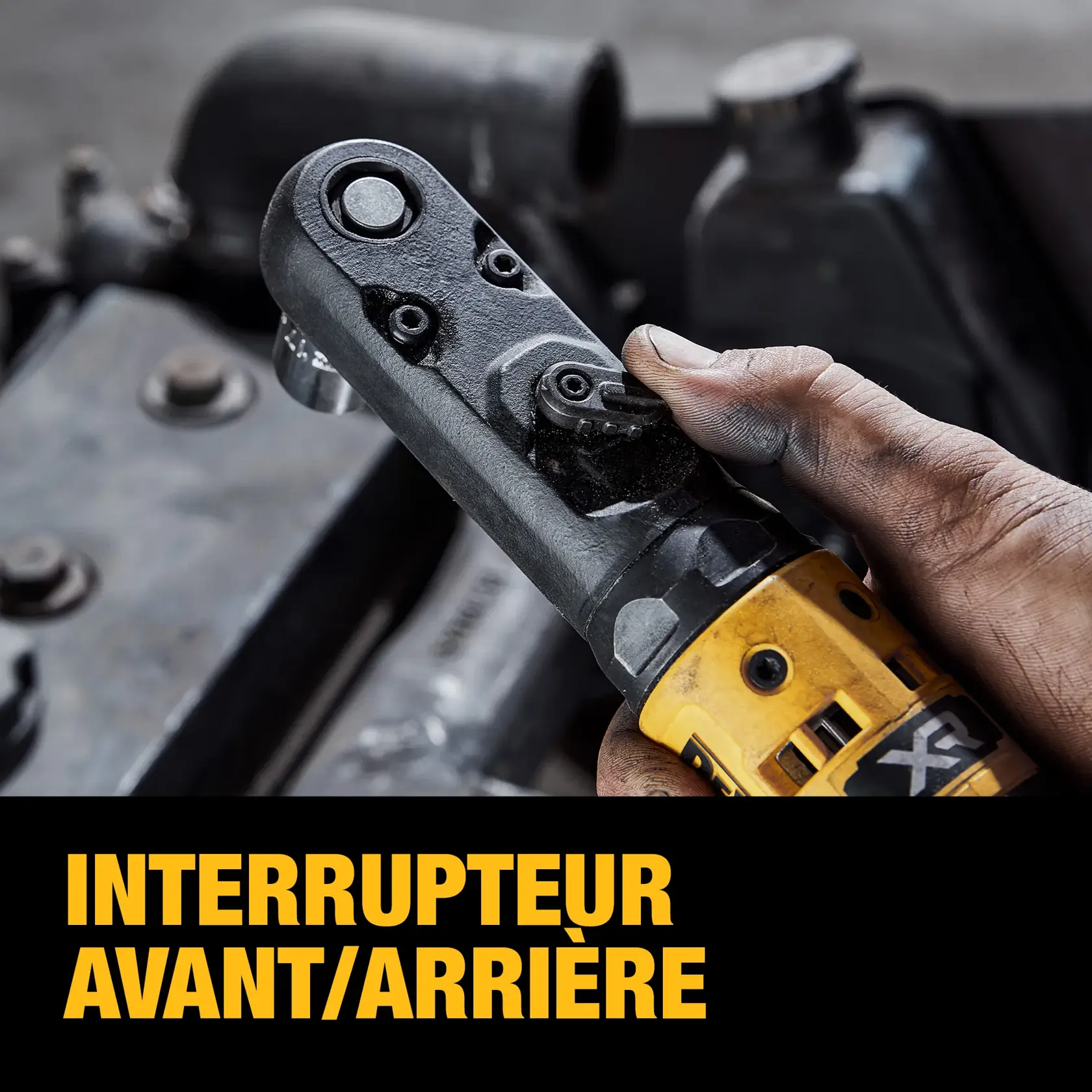 Close-up of a person's hand operating the forward/reverse switch on a yellow DEWALT power tool, with the text 'FORWARD/REVERSE SWITCH' below.