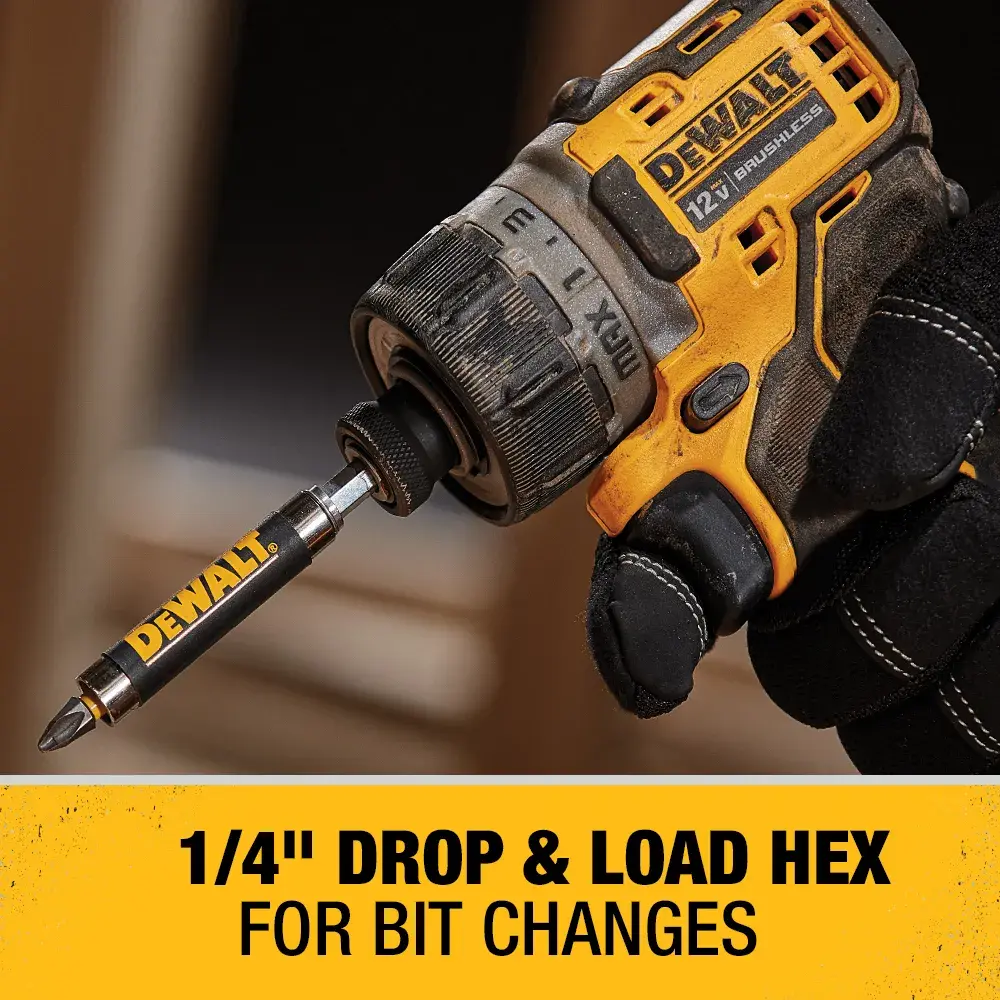 A gloved hand holds a DEWALT cordless power tool with a 1/4 inch drop and load hex bit attached. The yellow and black tool is shown against a blurred background, with text underneath highlighting its quick bit change feature.