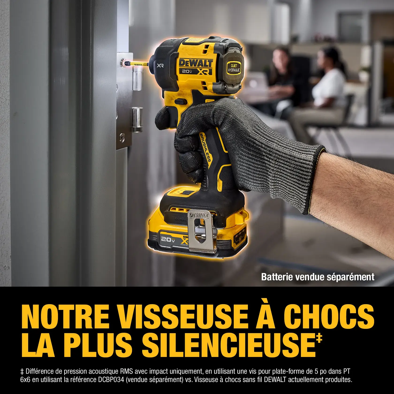A close-up of a gloved hand using a DEWALT 20V XR cordless impact driver to screw into a metal surface. The tool is yellow and black, and text on the image indicates 'Battery sold separately' and 'Our quietest impact driver.' There are blurred office workers in the background.