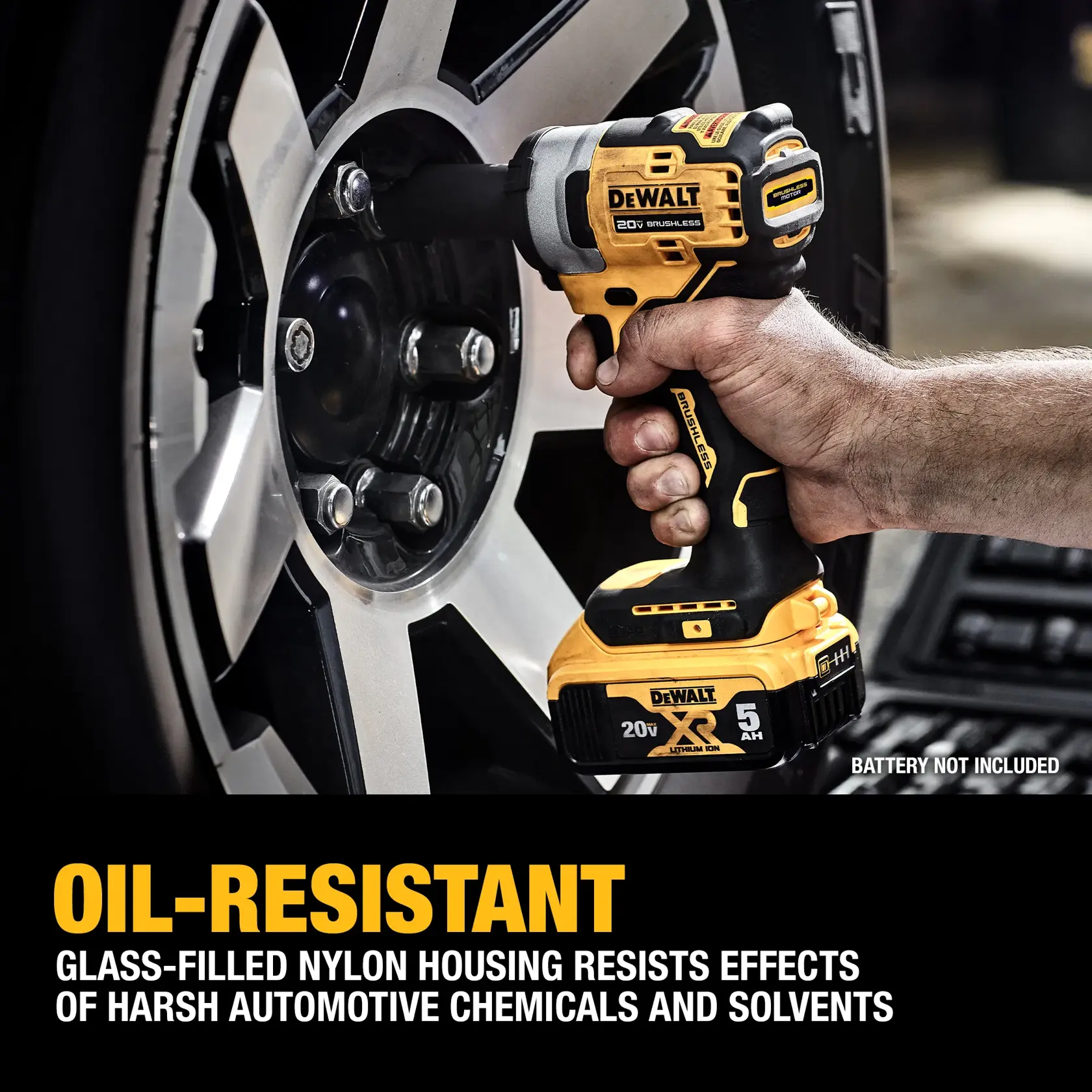 A person is using a DEWALT 20V cordless impact wrench to remove a lug nut from a car wheel. The tool is highlighted for its oil-resistant, glass-filled nylon housing, which resists harsh automotive chemicals and solvents. Text notes that the battery is not included.