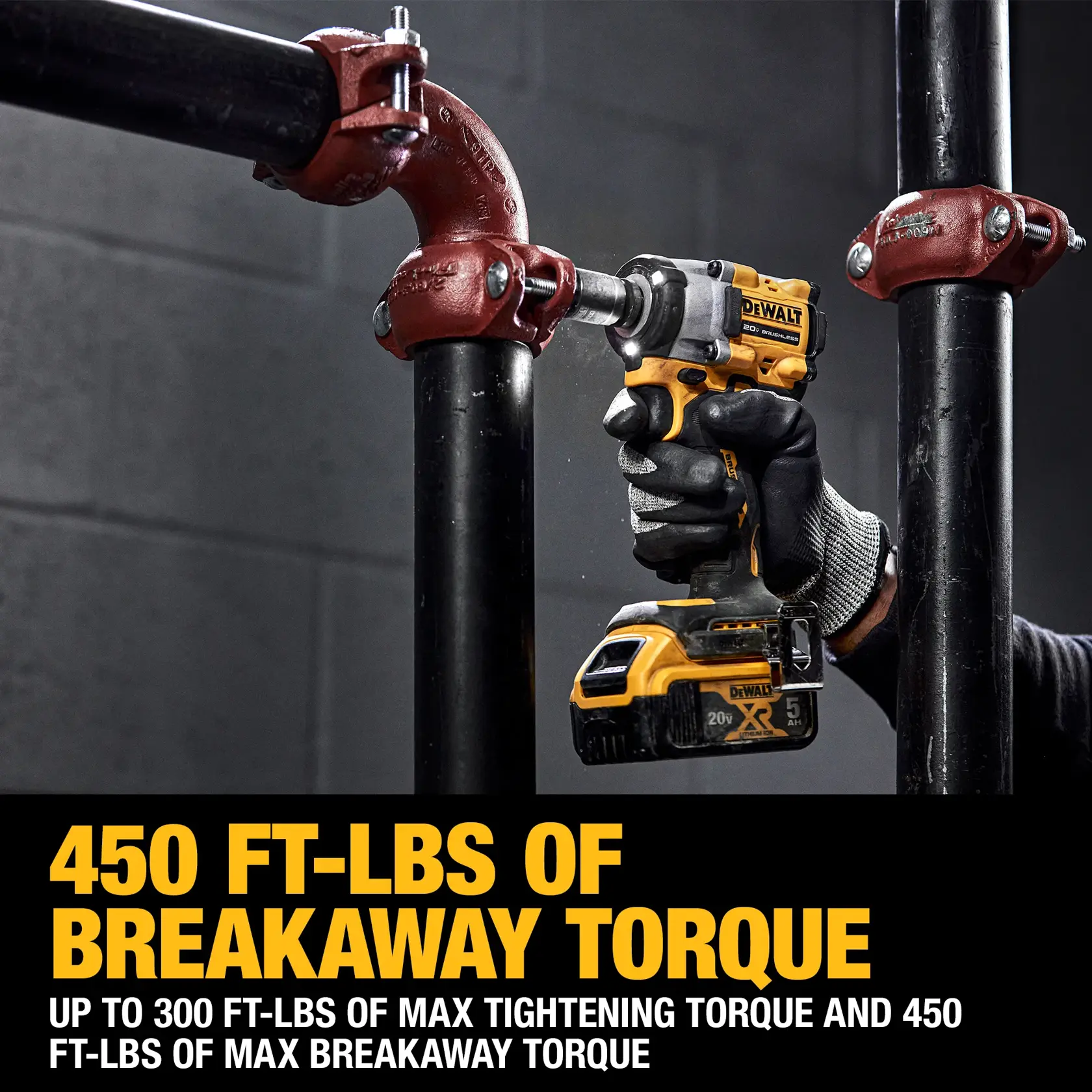 DEWALT impact wrench, model DCF923GP2, used on black piping, advertises 450 ft-lbs of breakaway torque.