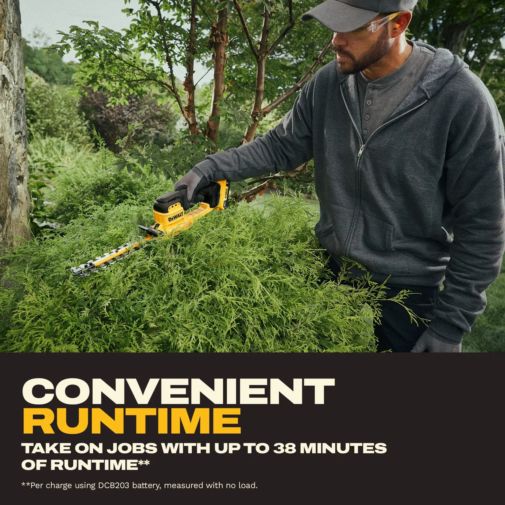 A person wearing gloves and a dark hoodie uses a yellow DEWALT hedge trimmer (SKU: DCHT823D1) to trim bushes outdoors. The image includes text highlighting that the tool offers convenient runtime, with jobs able to be completed in up to 38 minutes per charge, as measured using a DCB203 battery with no load.