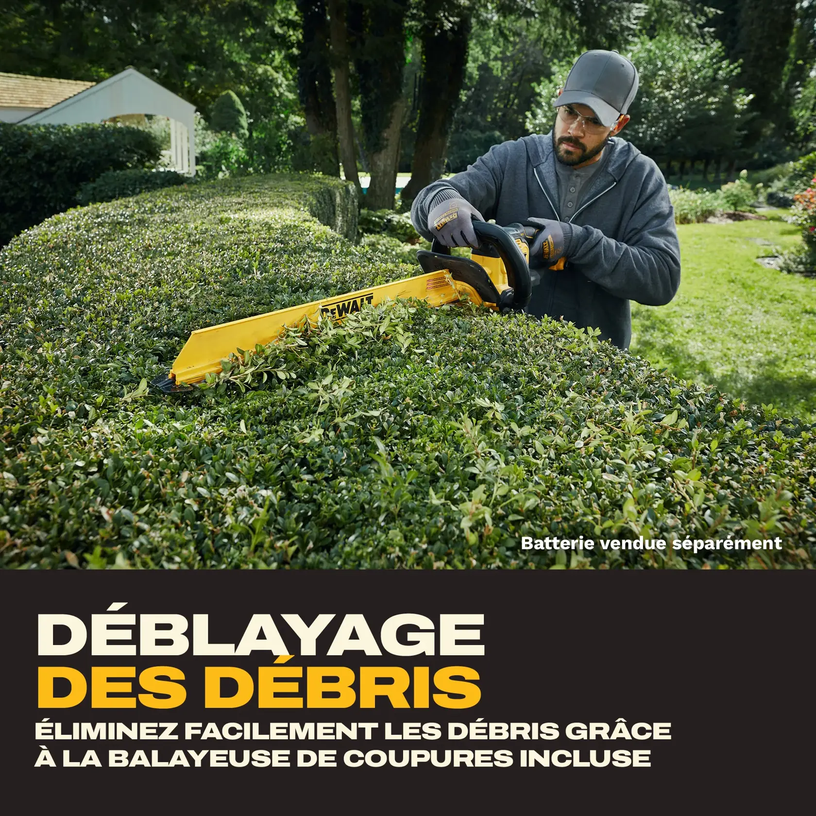 A person wearing gloves and a cap uses a DEWALT hedge trimmer with a yellow blade to clear debris from a hedge in a garden. The text highlights debris clearance and notes that the battery is sold separately.