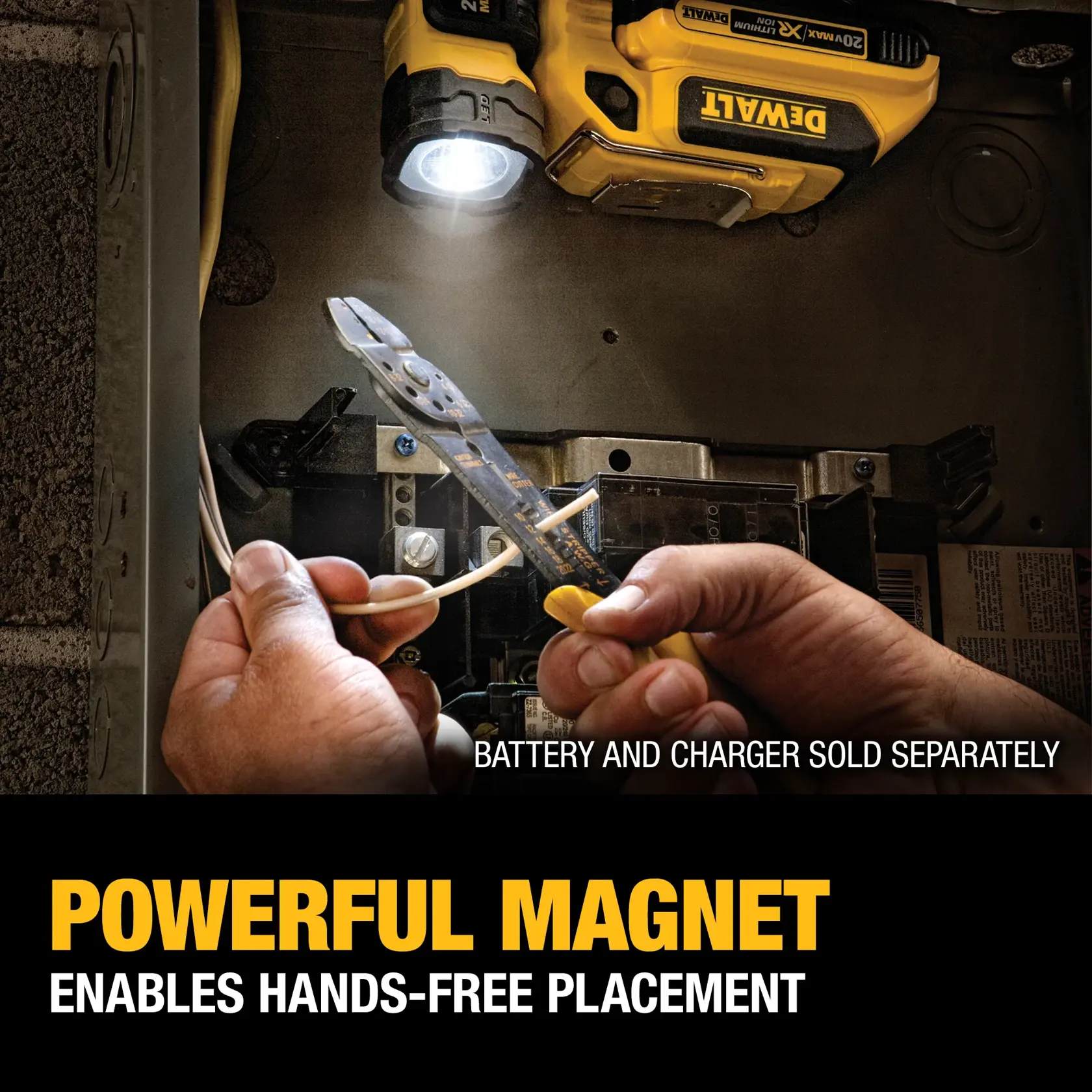 A DEWALT portable work light with a magnetic base is attached to a metal surface, shining light onto electrical wires being worked on with pliers. The text highlights its powerful magnet for hands-free placement. Battery and charger are sold separately.