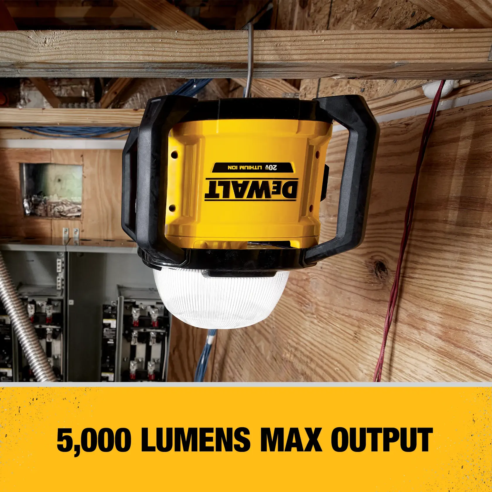 A DEWALT 20V lithium ion work light mounted on a wooden beam in a construction setting, with text indicating a maximum output of 5,000 lumens.