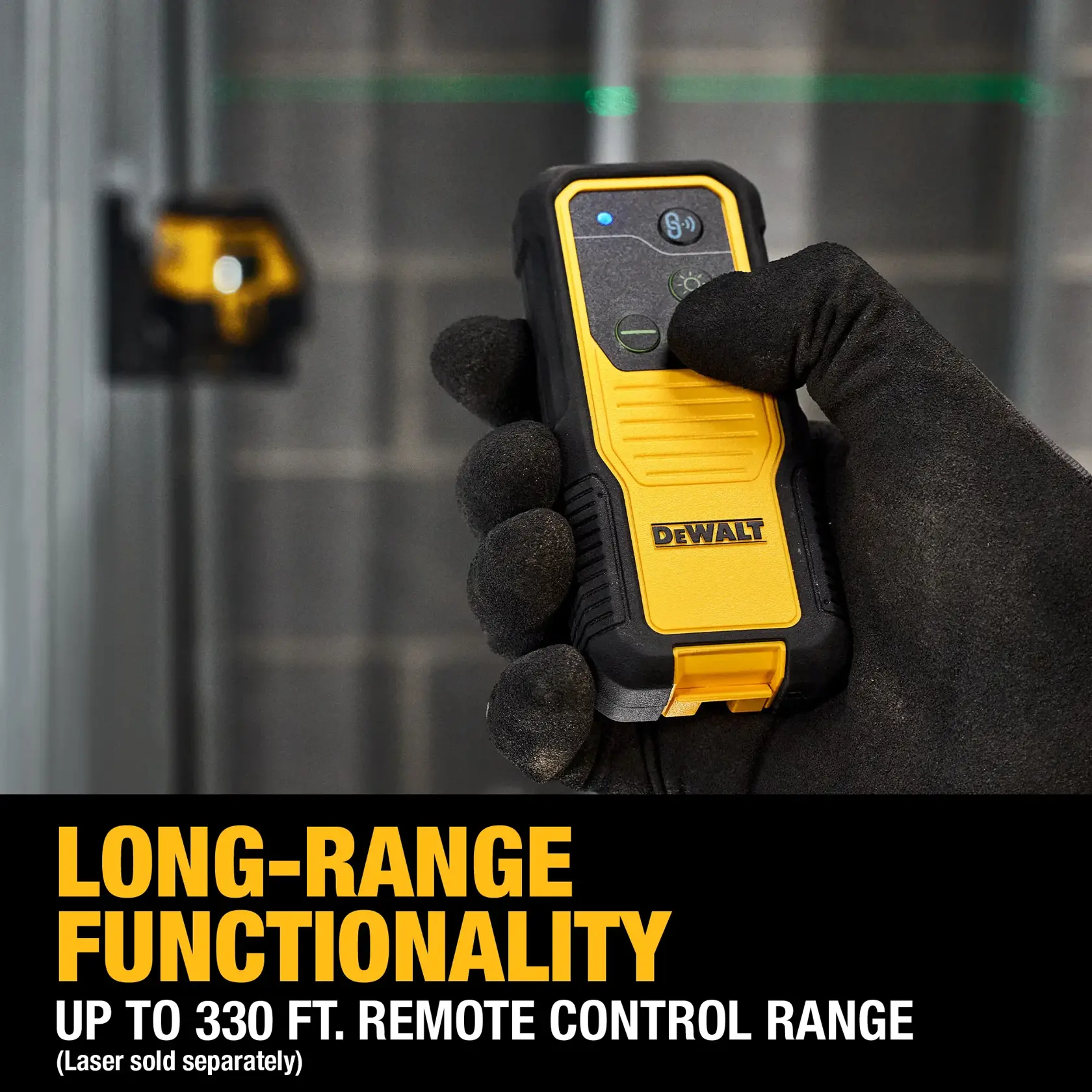 A gloved hand holding a DEWALT remote control device, with a yellow and black design. The background shows a DEWALT laser level tool mounted on a wall. Text at the bottom highlights long-range functionality of up to 330 feet for remote control range, and notes that the laser is sold separately.