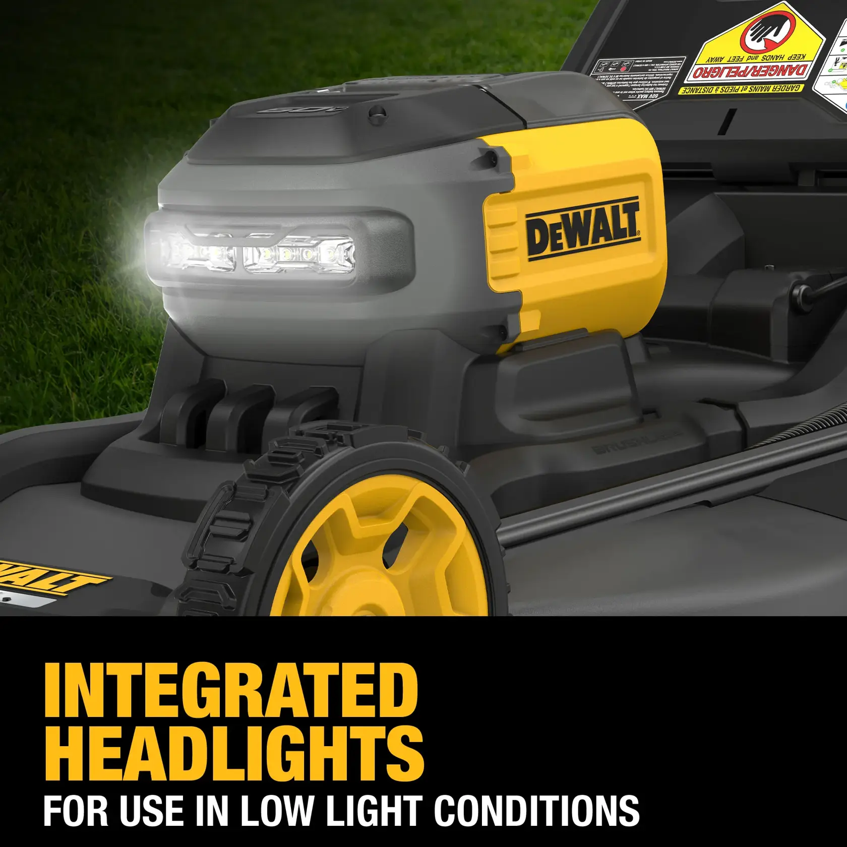 Close-up of a DEWALT lawn mower with integrated headlights illuminated, designed for use in low light conditions. The mower features yellow and black accents and rugged wheels.