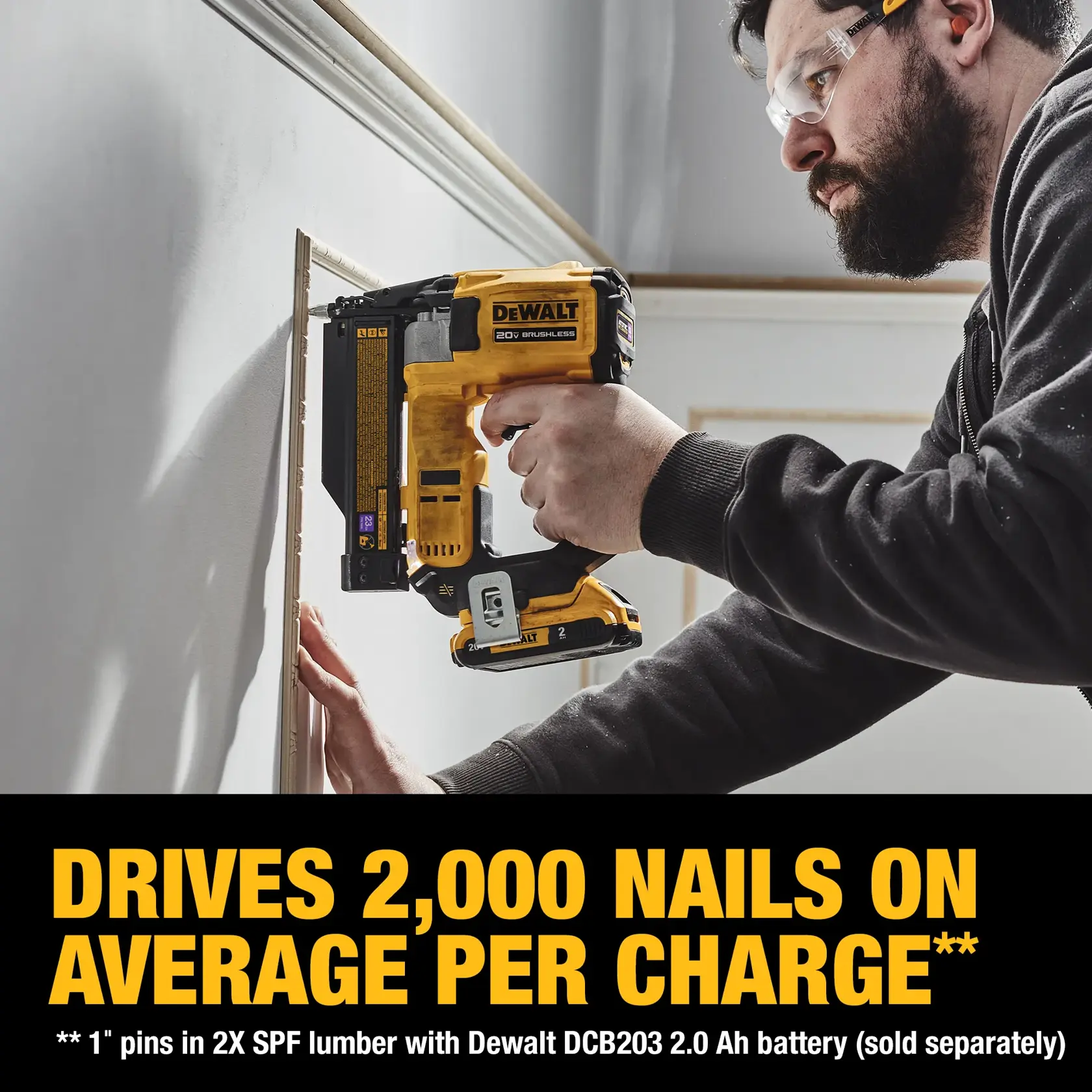 A person is using a DEWALT 20V brushless cordless nailer to attach trim to a wall. The text on the image highlights that the tool drives 2,000 nails on average per charge with a specified battery (sold separately).