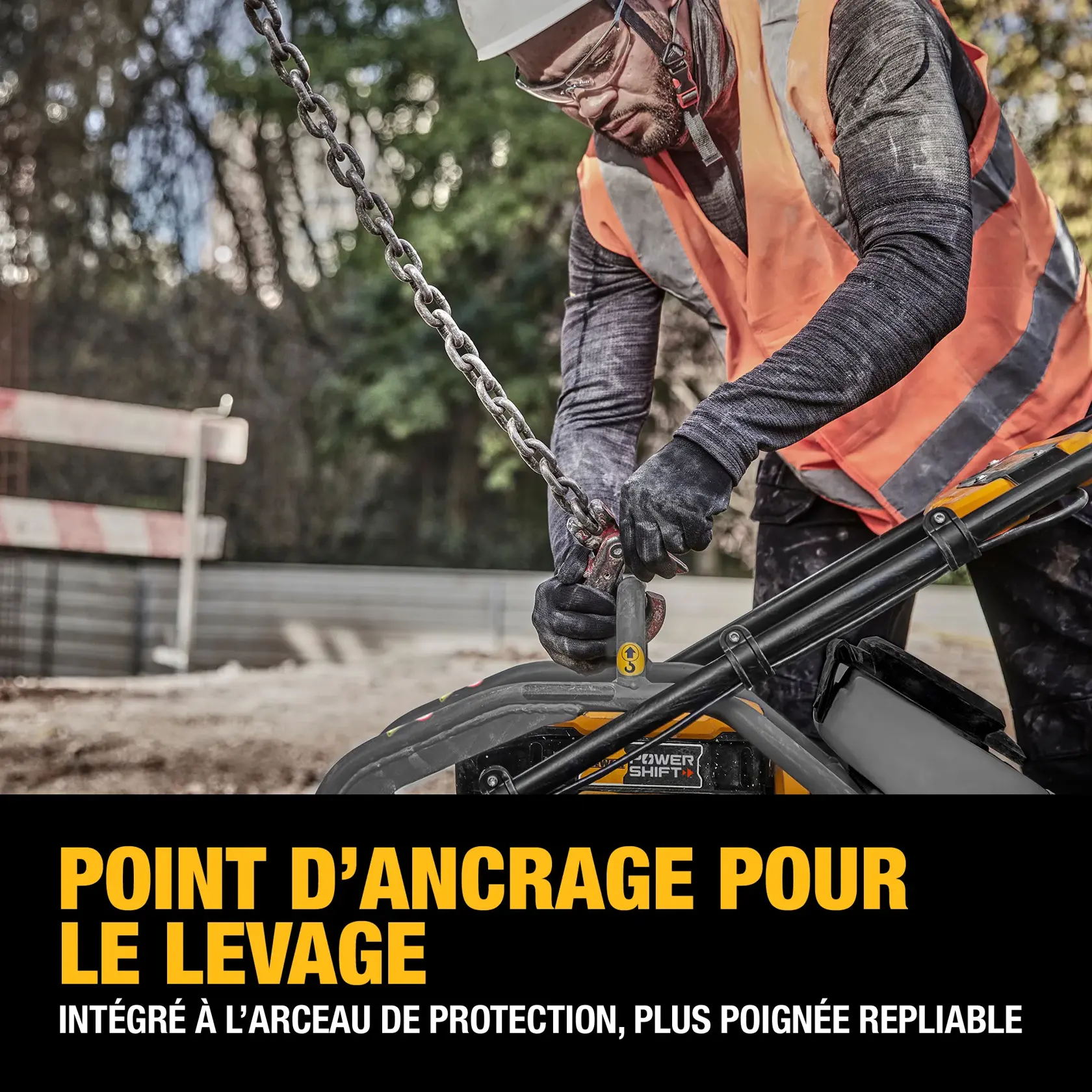 A construction worker wearing a safety vest and gloves attaches a lifting chain to the dedicated lift point on a DEWALT machine. The lift point is integrated into the roll cage and foldable handles. The foreground contains bold text describing the dedicated lift point feature.