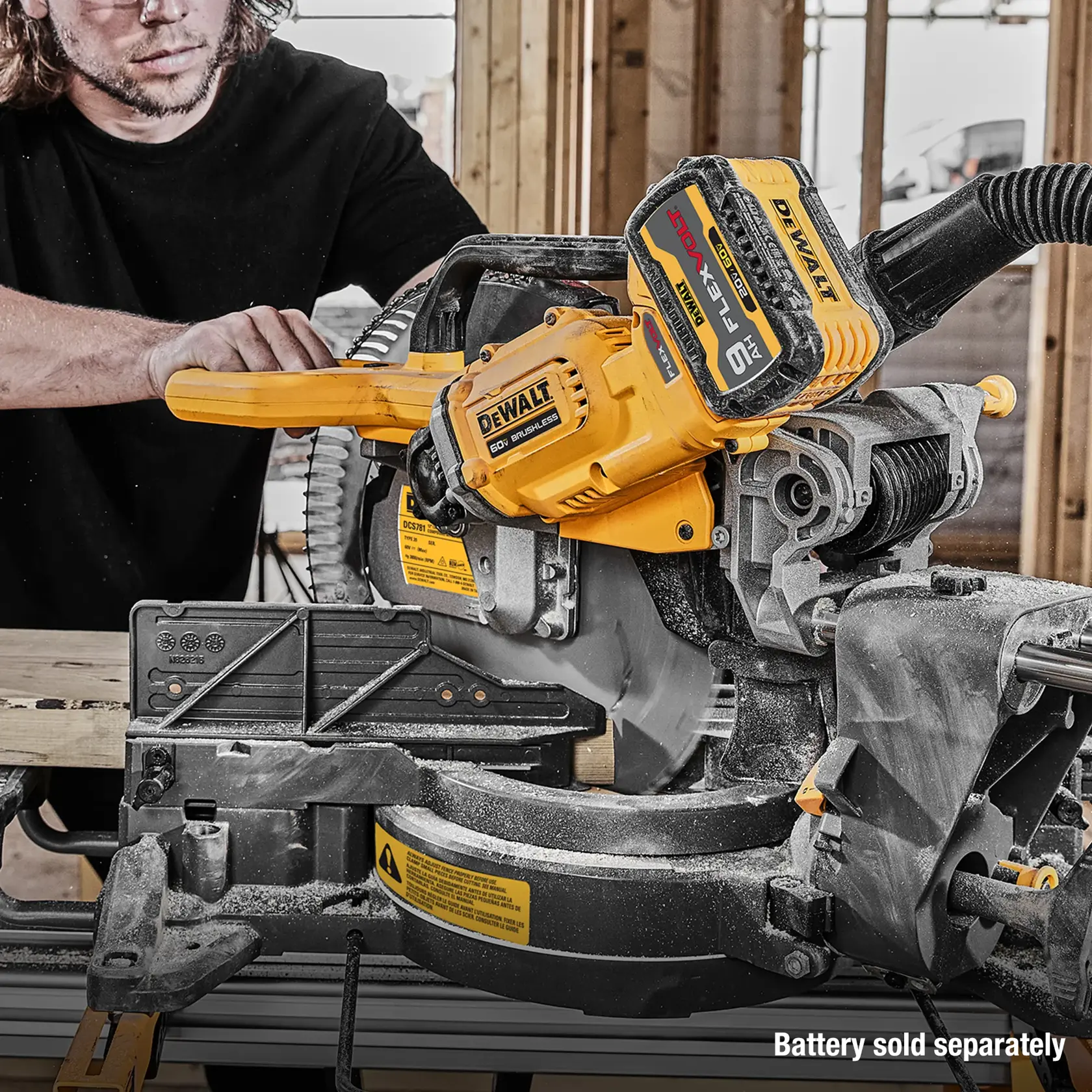 A person using a DEWALT cordless miter saw with a yellow design on a wooden work site. The tool has a visible battery pack labeled 'FLEXVOLT 60V MAX'. The slogan 'Battery sold separately' appears in the lower right corner.