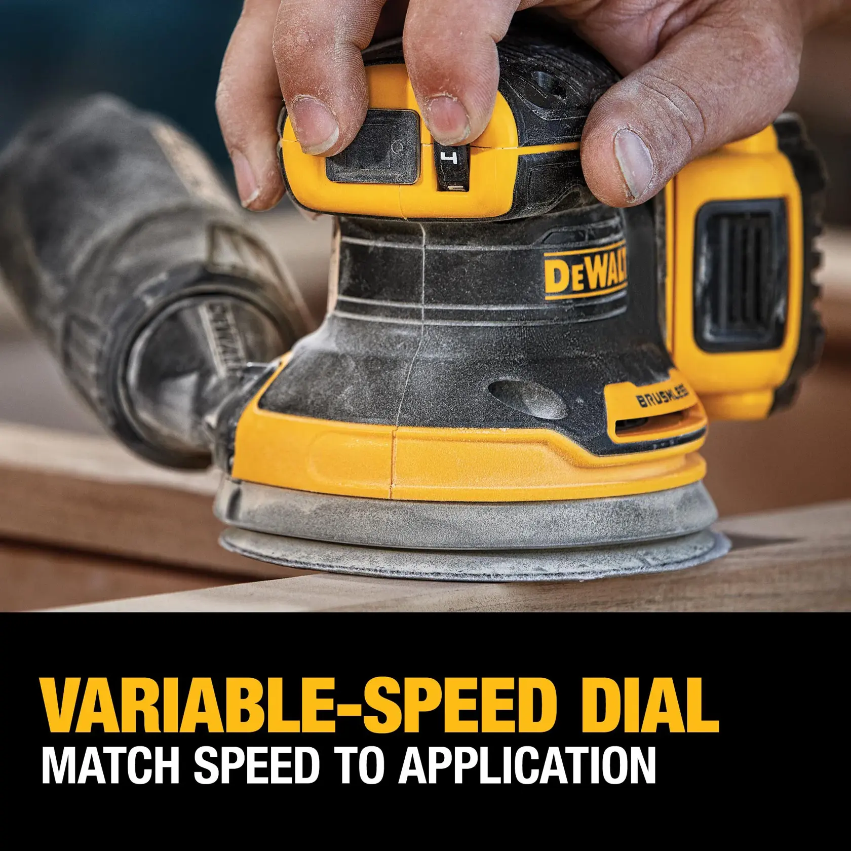 DEWALT sander with a variable-speed dial being adjusted on wood, highlighting speed control feature.