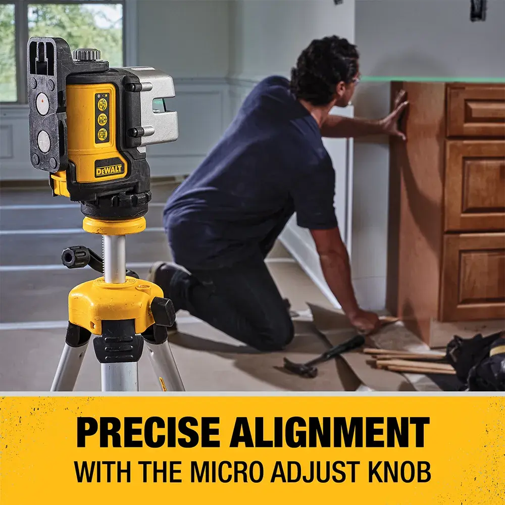 A DEWALT DW089CG green line laser level mounted on a tripod is shown in a room. A person is installing cabinetry, using the laser to align measurements precisely. The text at the bottom reads: 'Precise Alignment with the Micro Adjust Knob.'