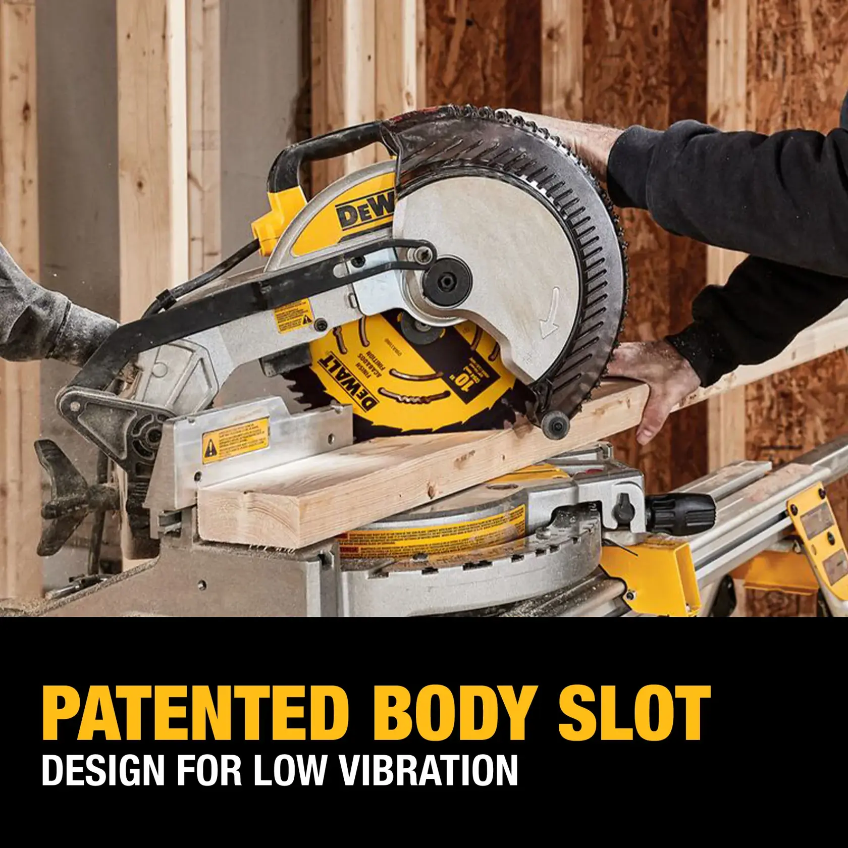 A DEWALT miter saw cutting a piece of wood in a construction setting. The saw blade features a patented body slot design for low vibration, as highlighted in the text below the image.
