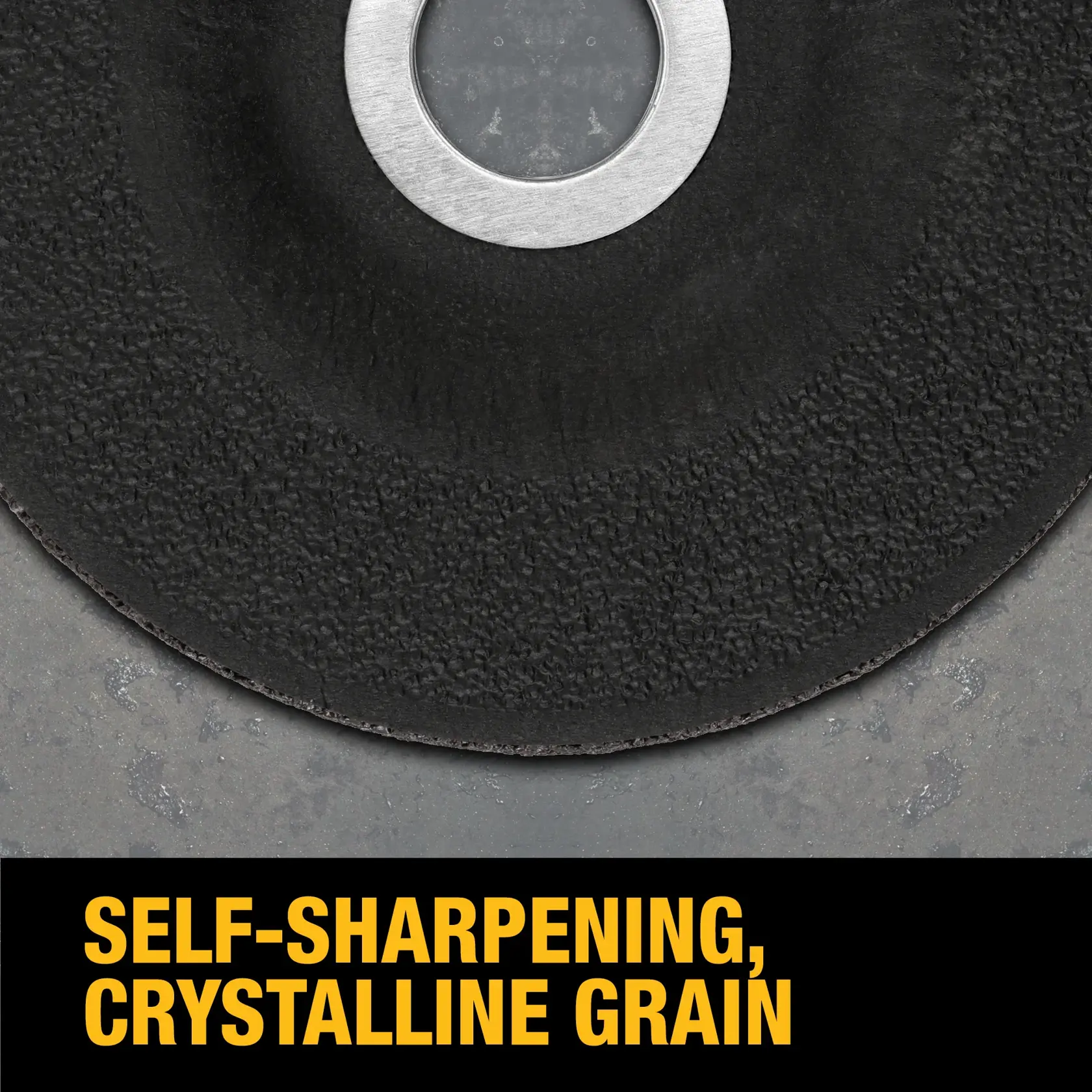 Close-up of a DEWALT grinding or cutting disc with a rough abrasive surface and metal center. The text below reads 'SELF-SHARPENING, CRYSTALLINE GRAIN' in bold yellow letters.