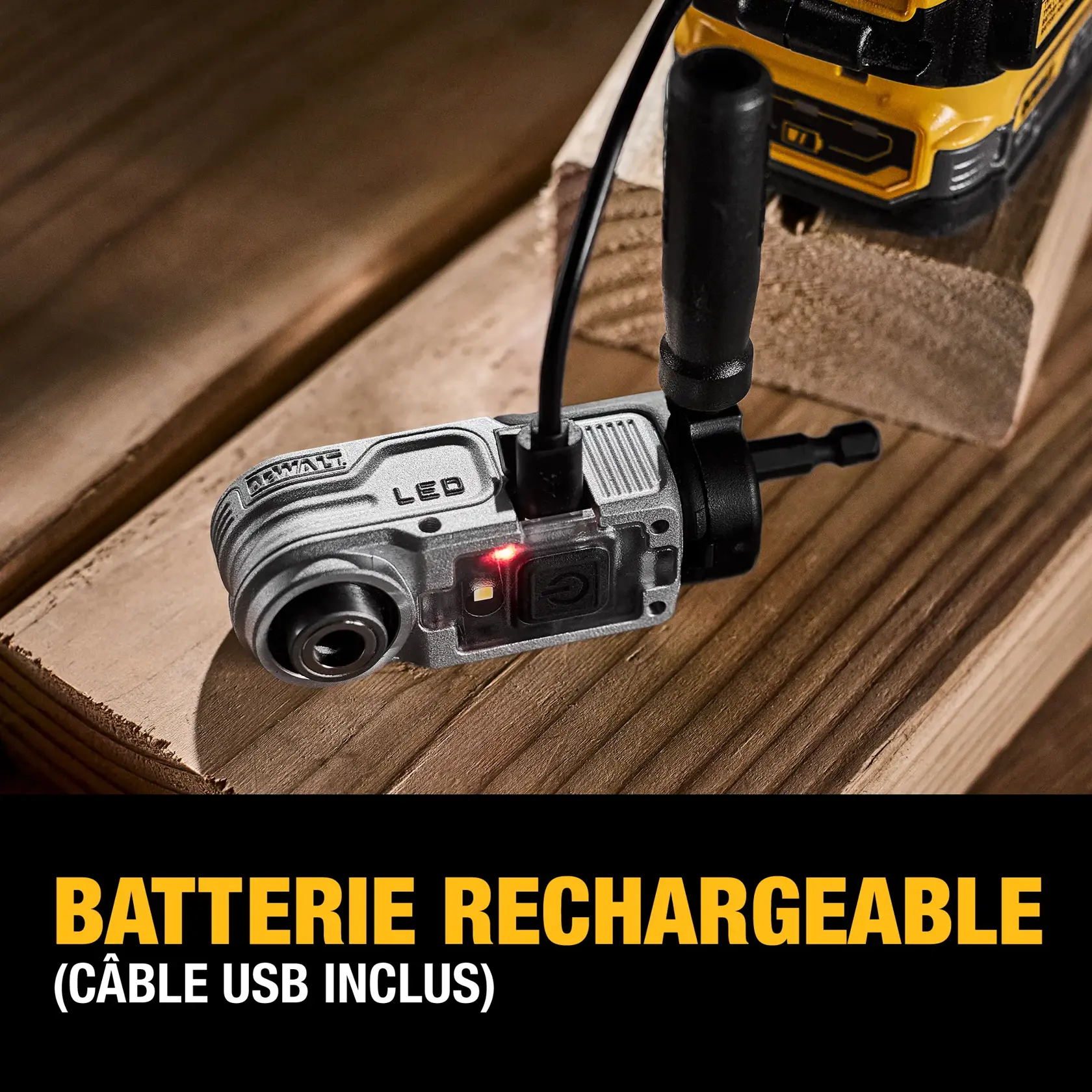 A DEWALT tool attachment with LED light is shown on a wooden surface while being plugged in via a USB cable for charging. The text at the bottom reads: 'Rechargeable battery (USB cable included)'.