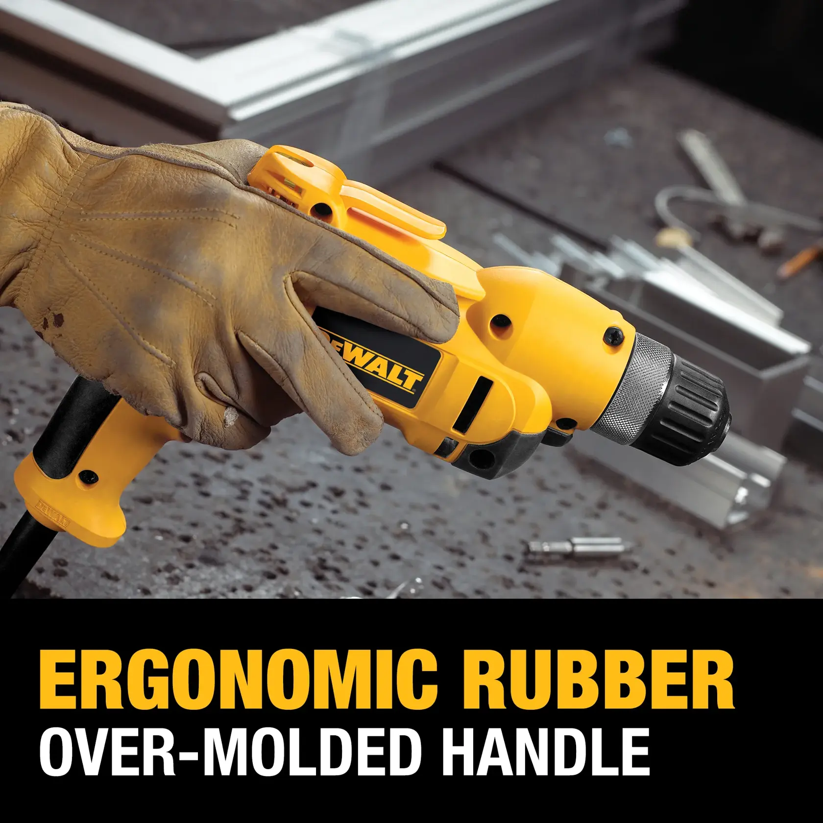 A gloved hand holding a yellow DEWALT power drill with an ergonomic rubber over-molded handle. The drill is being used on a workbench with metal parts and tools in the background. Text on the image reads: 'ERGONOMIC RUBBER OVER-MOLDED HANDLE.'