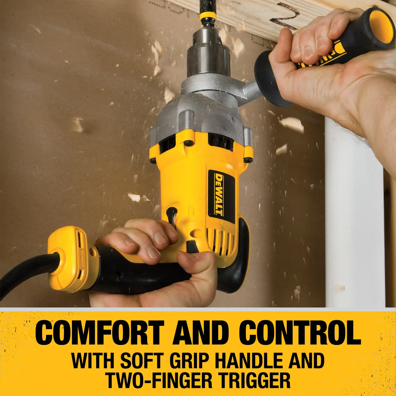 A yellow DEWALT power drill with a soft grip handle and two-finger trigger is shown in use drilling through wood, with wood shavings flying. The product emphasizes comfort and control.