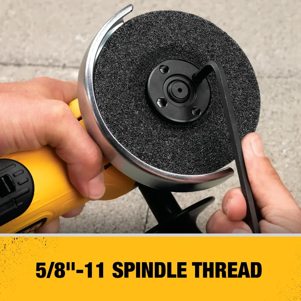 Close-up of hands adjusting the spindle thread on a DEWALT angle grinder using a wrench. The image highlights the 5/8''-11 spindle thread feature.