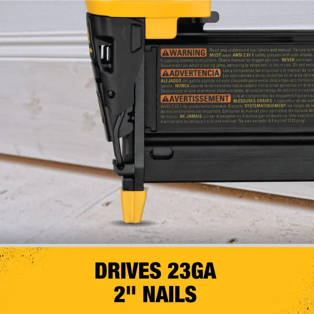 Close-up of a DEWALT nailer driving a 23-gauge, 2-inch nail into trim with a yellow strip at the bottom that reads: 'DRIVES 23GA 2'' NAILS'.