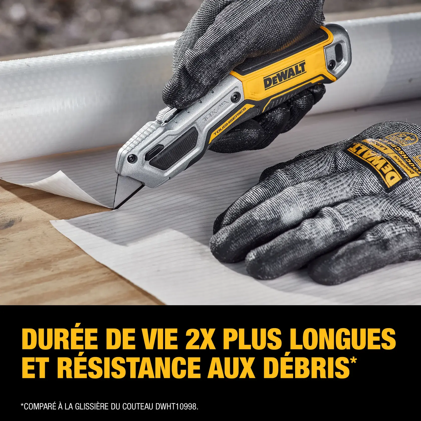 A close-up image of a person wearing black DEWALT work gloves and using a DEWALT utility knife (model DWHT10999) to cut white construction material on a wooden surface. Text on the image reads: '2X longer life and resistance to debris*', with a note: '*Compared to the slider of utility knife DWHT10998.'