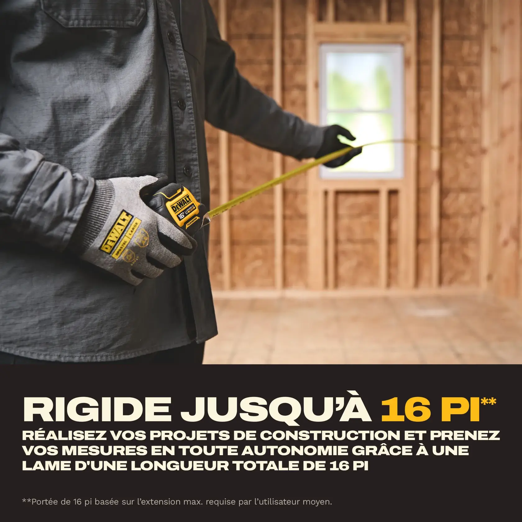 A person wearing gloves uses a DEWALT tape measure to measure a distance inside a room under construction, with text indicating a 16-foot maximum reach for construction projects.