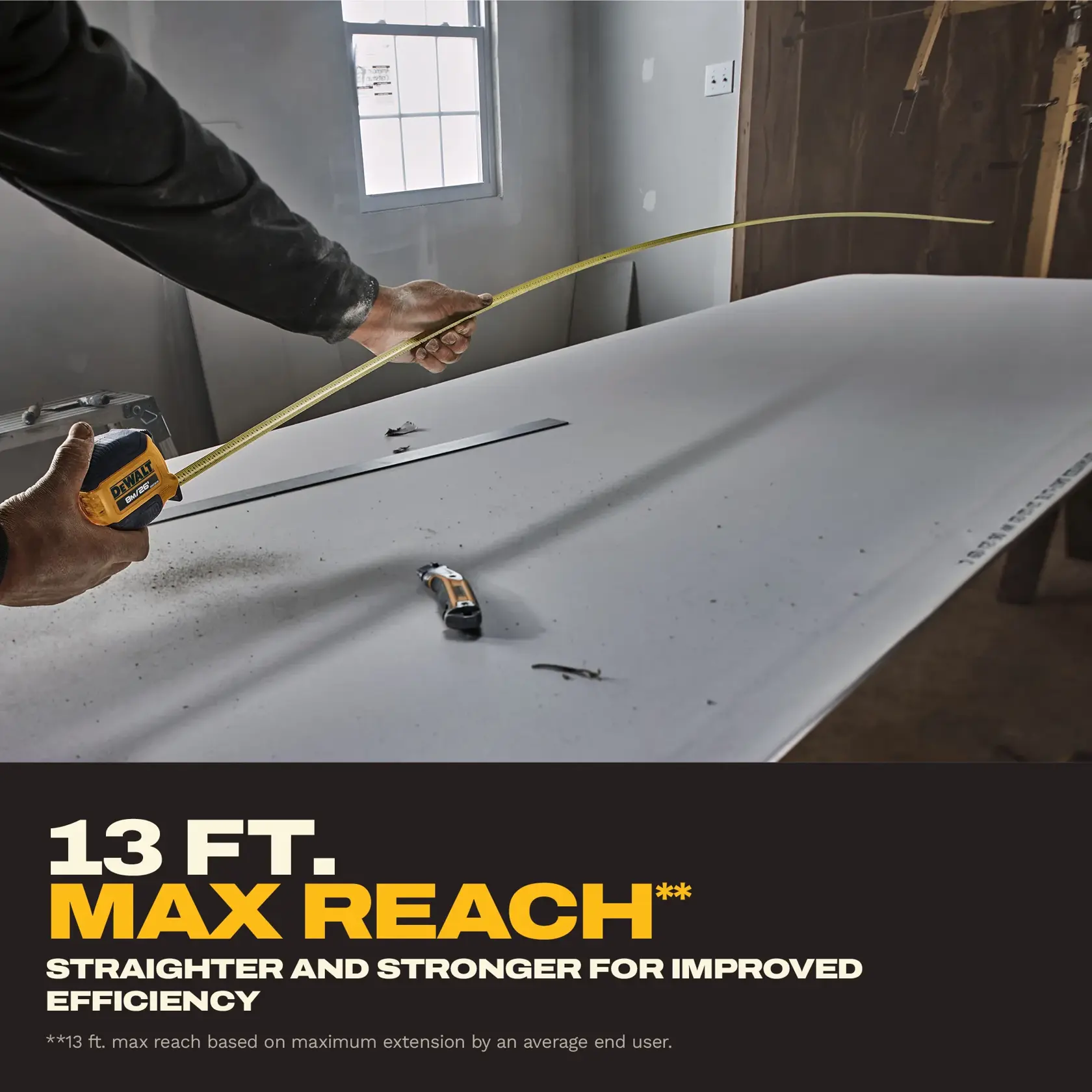 A person measures a long distance on a work surface using a DEWALT tape measure, with the tape extended. Text on the image highlights the 13 ft. max reach of the tape, emphasizing straightness and strength for improved efficiency. Other tools are visible on the work surface.