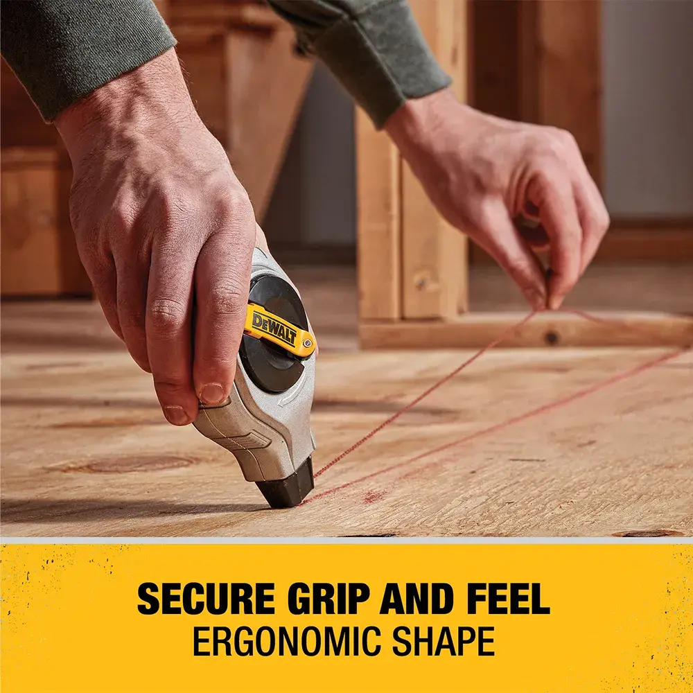 A person uses a DEWALT tool to mark a straight line on a wooden surface, with text that reads 'SECURE GRIP AND FEEL ERGONOMIC SHAPE.'