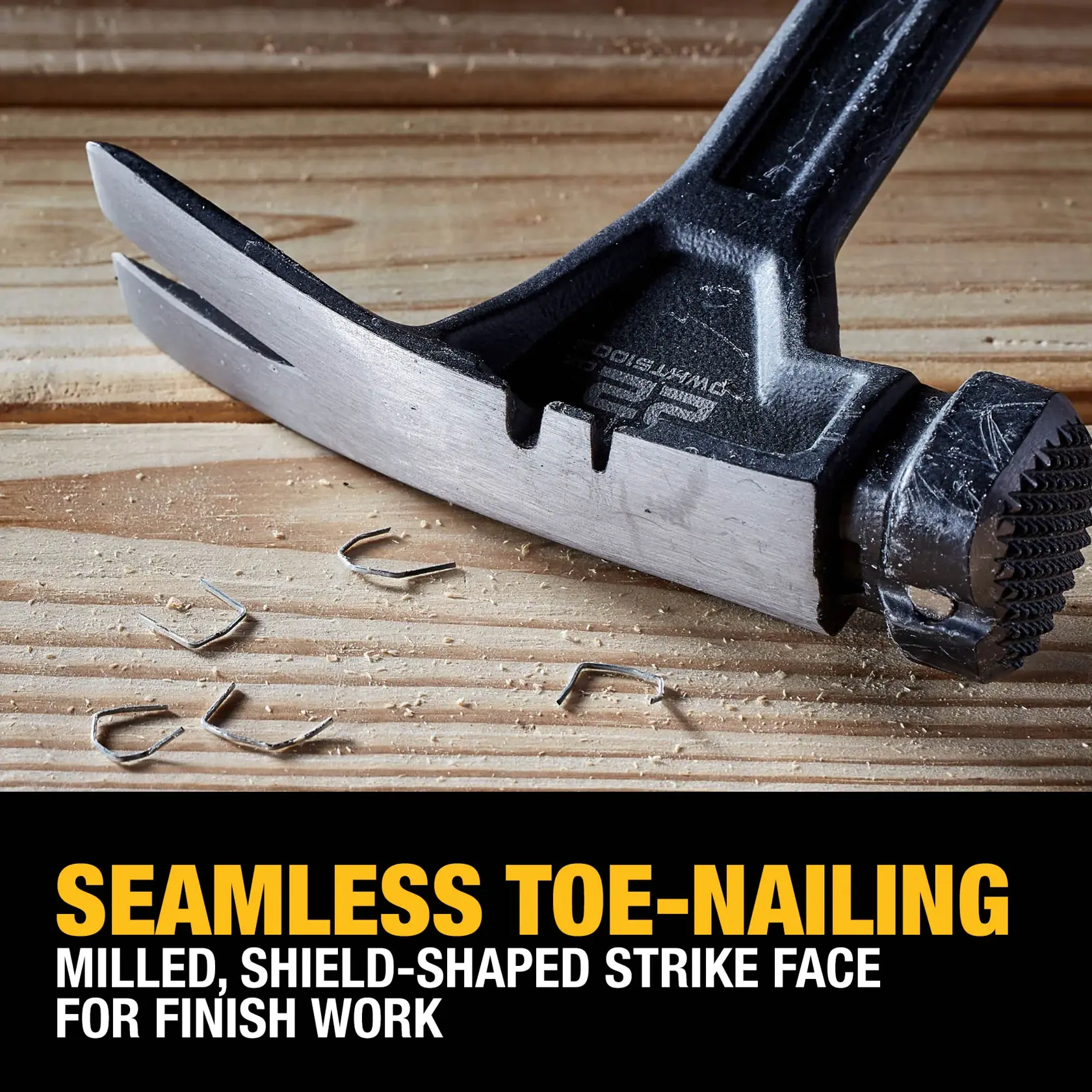 Close-up view of a DEWALT hammer head on a wooden surface with bent nails, highlighting its milled, shield-shaped strike face for seamless toe-nailing and finish work. Text overlay at the bottom describes the features.