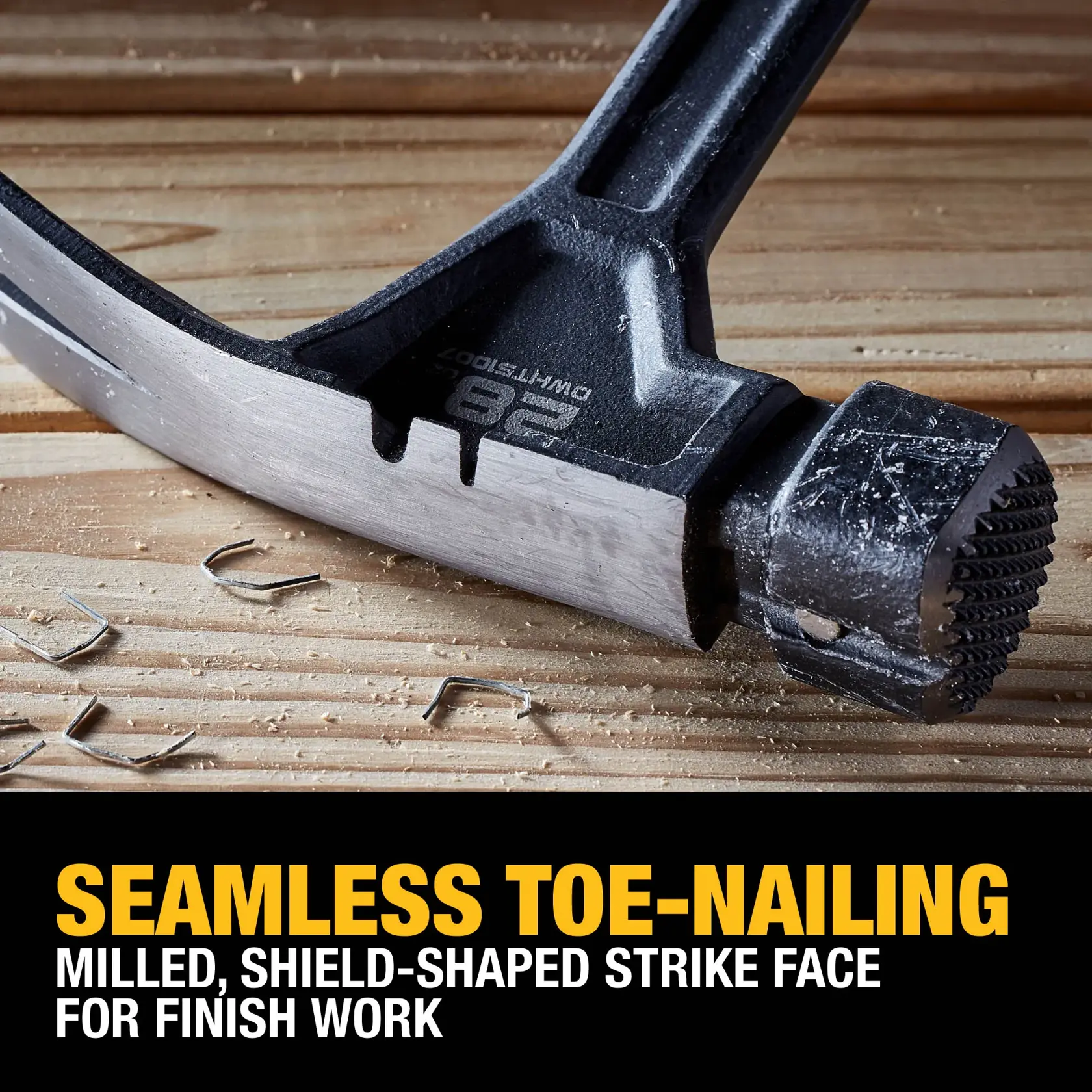 Close-up of a DEWALT hammer head, showing a milled, shield-shaped strike face and a claw end. The hammer is placed on a wooden surface with nails around, emphasizing its feature for seamless toe-nailing and finish work. Bold yellow and white text below highlights the hammer’s design and functionality.