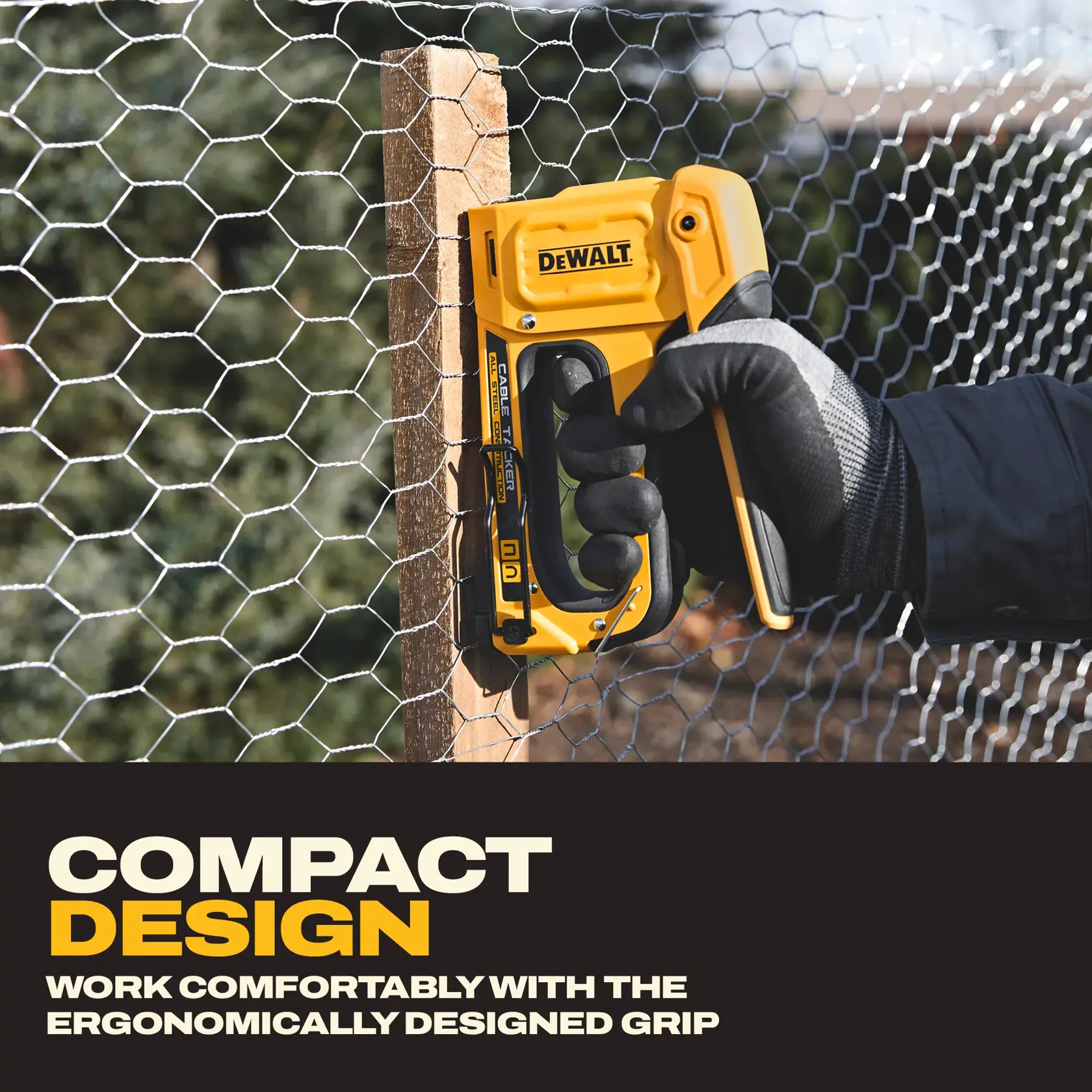 A person wearing gloves uses a yellow DEWALT staple gun (model DWHT70100) to attach wire mesh to a wooden post. The product is highlighted as having a compact design and an ergonomically designed grip for comfortable use.